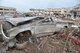 Cars in front of the Moore, Okla. Medical Center show the destruction of the EF-5 Tornado that hit, May 20. The Orange X spray painted on the cars indicates that the vehicle was checked and cleared of any victims.  (U.S. Air Force photo by Senior Airman Mark Hybers)