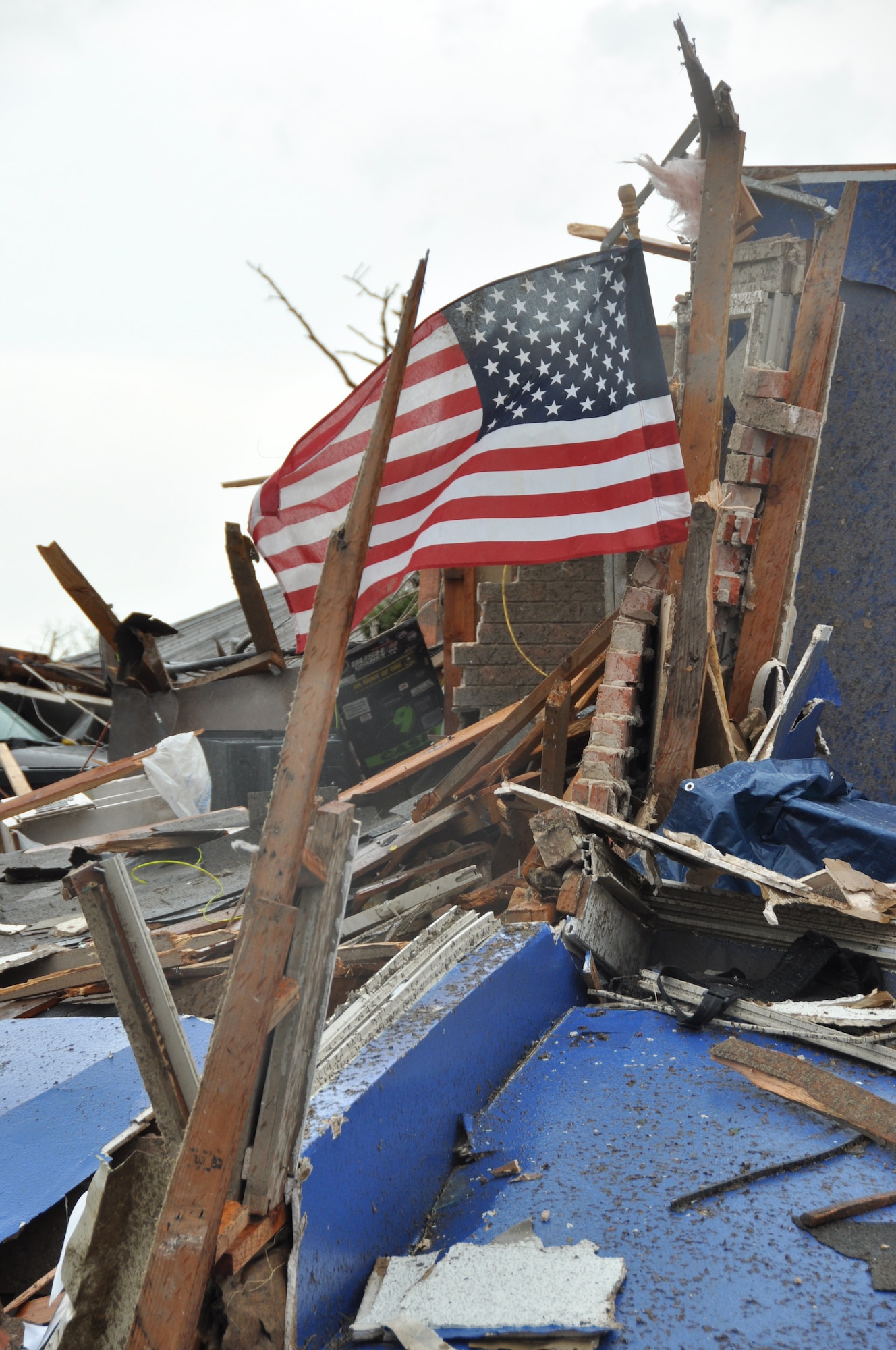 A United States flag flies from the ruble of a home destroyed in Moore, Okla. A powerful EF-5 tornado touched down approximately three miles south of Tinker AFB. (U.S. Air Force photo by Maj. Jon Quinlan)
