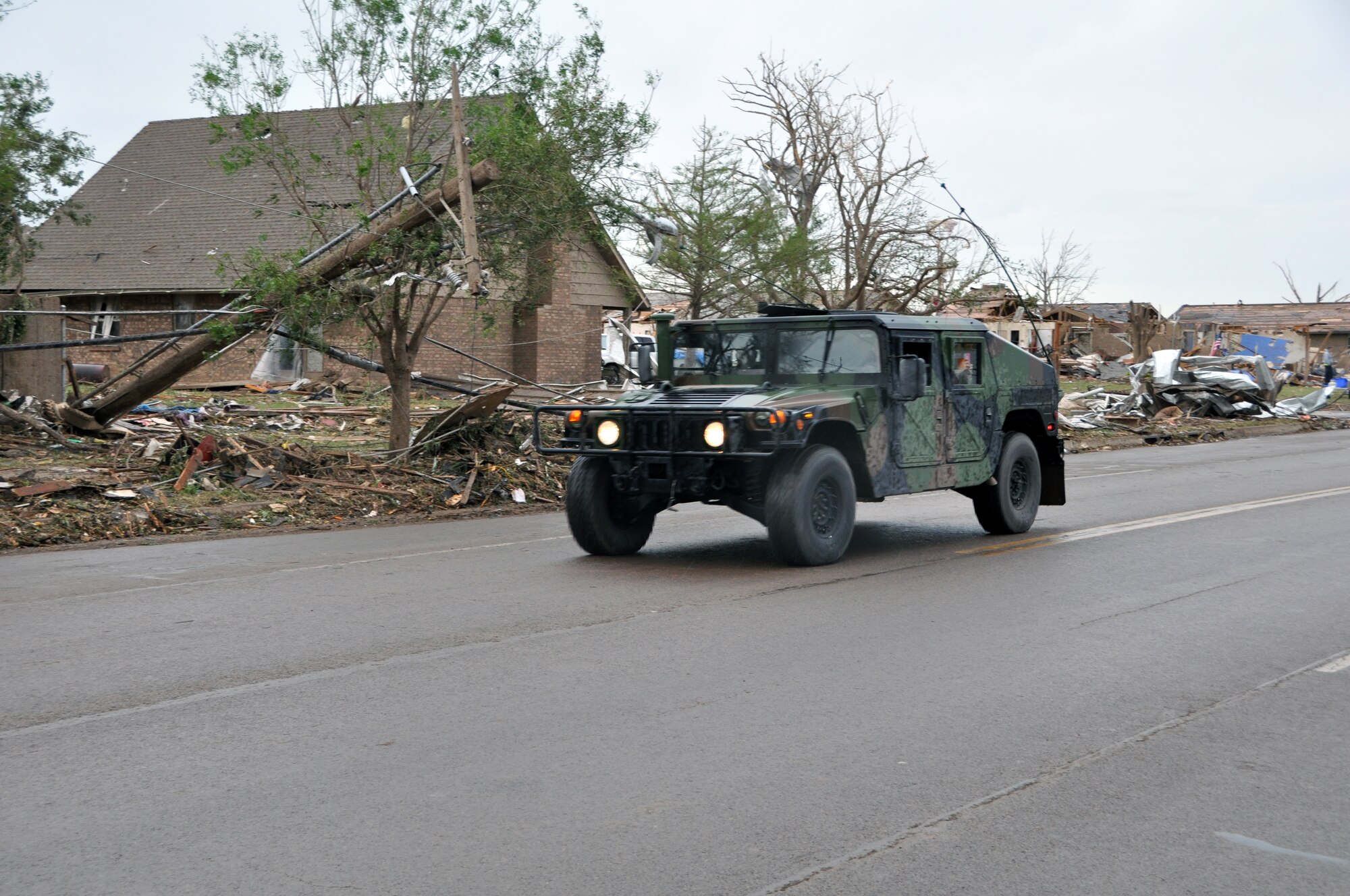 Members of the Oklahoma National Guard drive down Telephone Road preparing to get into the neighborhoods devastated by the massive tornado that struck Moore Okla., on May 20, 2013.  (U.S. Air Force photo by Senior Airman Mark Hybers)