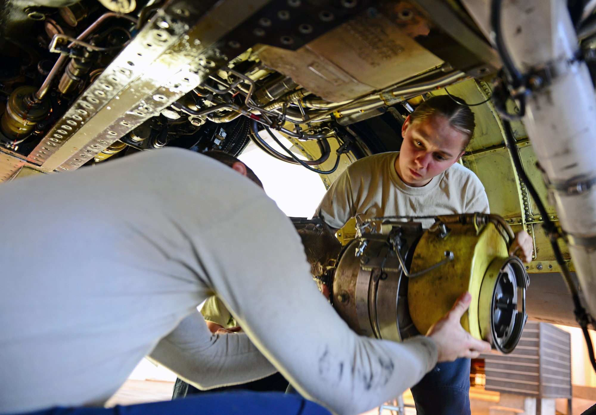 Staff Sgts. Eddie Santana and AnnMarie Ringer install a jet fuel starter on an F-16 Fighting Falcon, May 14, 2013, at Aviano Air Base, Italy. Crew chiefs are responsible for inspecting aircraft structures, systems and components on the F-16 Fighting Falcon. Santana and Ringer are both dedicated crew chiefs assigned to the 510th Aircraft Maintenance Unit. (U.S. Air Force photo/Airman 1st Class Matthew Lotz)