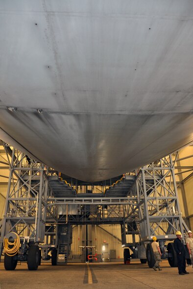 Troops from the 439th Maintenance Squadron prepare to tow a C-5 Galaxy into Westover's Regional Isochronal dock, May 22, 2013, to test the newly-constructed mobile tail enclosure. Crews broke ground April 1, 2012, for the $5 million MTE, is a moveable structure on rails that will protect maintenance troops from harsh New England weather. The MTE is the largest structure of its kind in the Air Force. (U.S. Air Force photo/SrA Kelly Galloway)