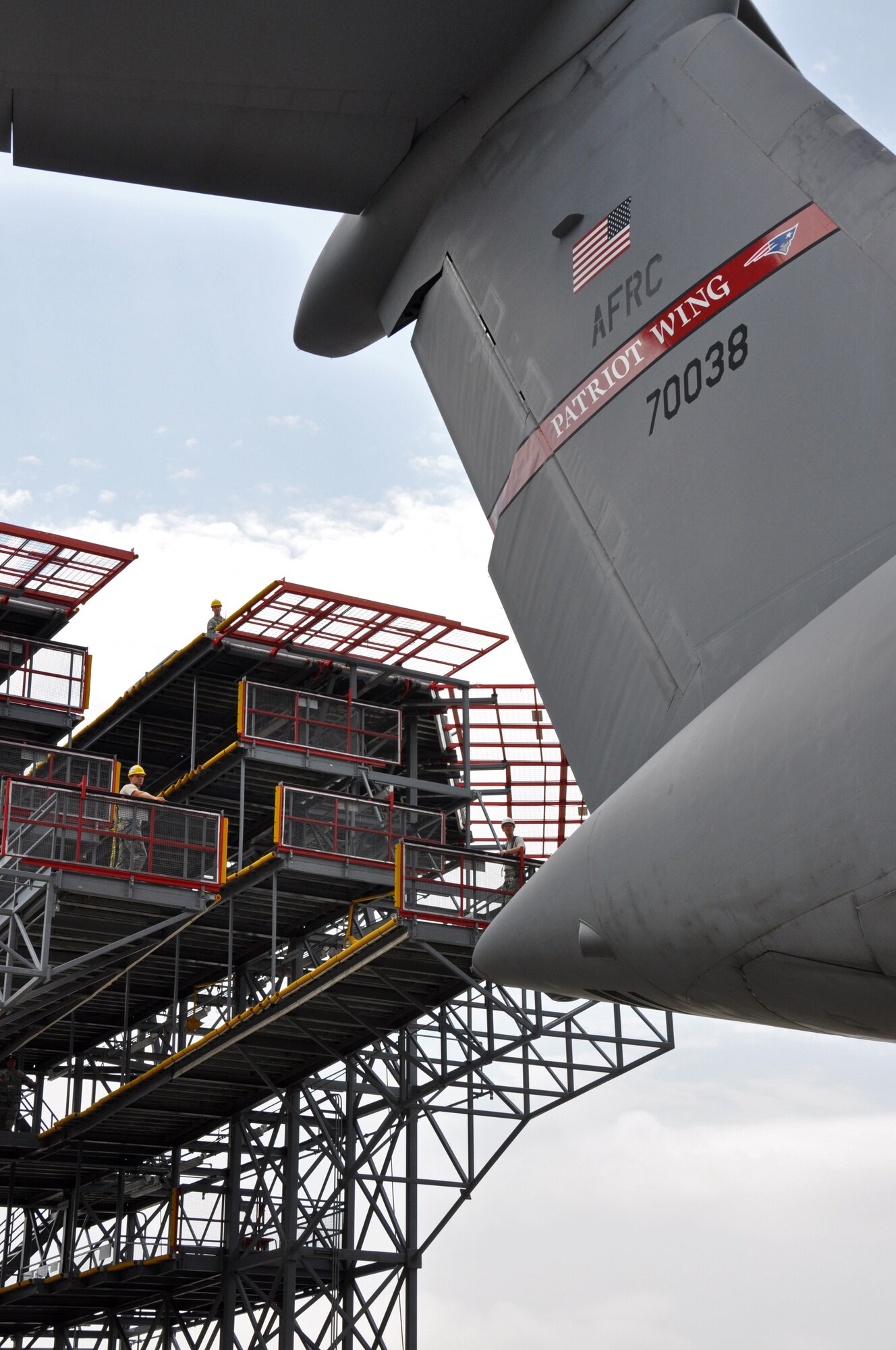 Troops from the 439th Maintenance Squadron prepare to tow a C-5 Galaxy into Westover's Regional Isochronal dock, May 22, 2013, to test the newly-constructed mobile tail enclosure. Crews broke ground April 1, 2012, for the $5 million MTE, is a moveable structure on rails that will protect maintenance troops from harsh New England weather. The MTE is the largest structure of its kind in the Air Force. (U.S. Air Force photo/SrA Kelly Galloway)