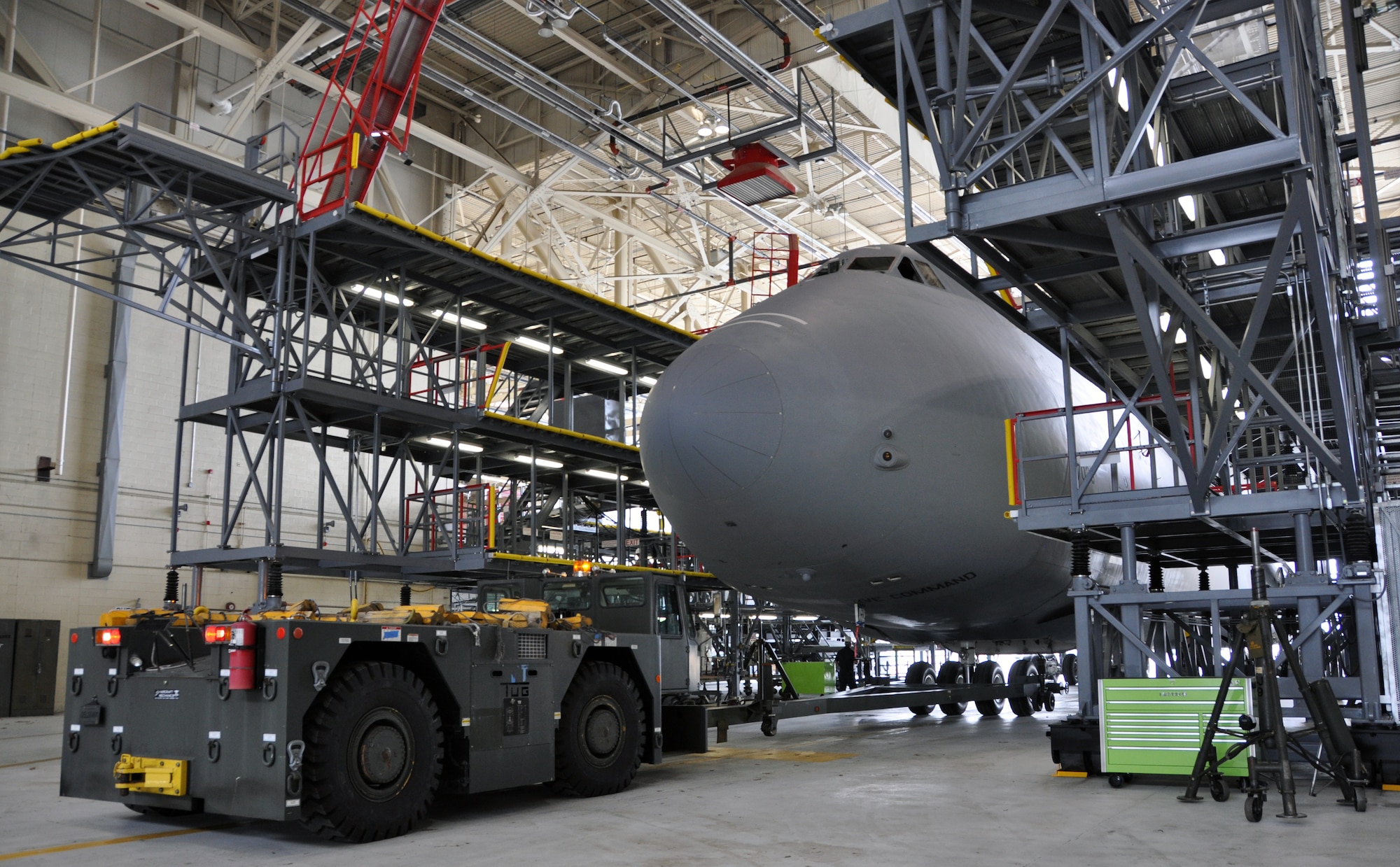 Troops from the 439th Maintenance Squadron prepare to tow a C-5 Galaxy into Westover's Regional Isochronal dock, May 22, 2013, to test the newly-constructed mobile tail enclosure. Crews broke ground April 1, 2012, for the $5 million MTE, is a moveable structure on rails that will protect maintenance troops from harsh New England weather. The MTE is the largest structure of its kind in the Air Force. (U.S. Air Force photo/SrA Kelly Galloway)