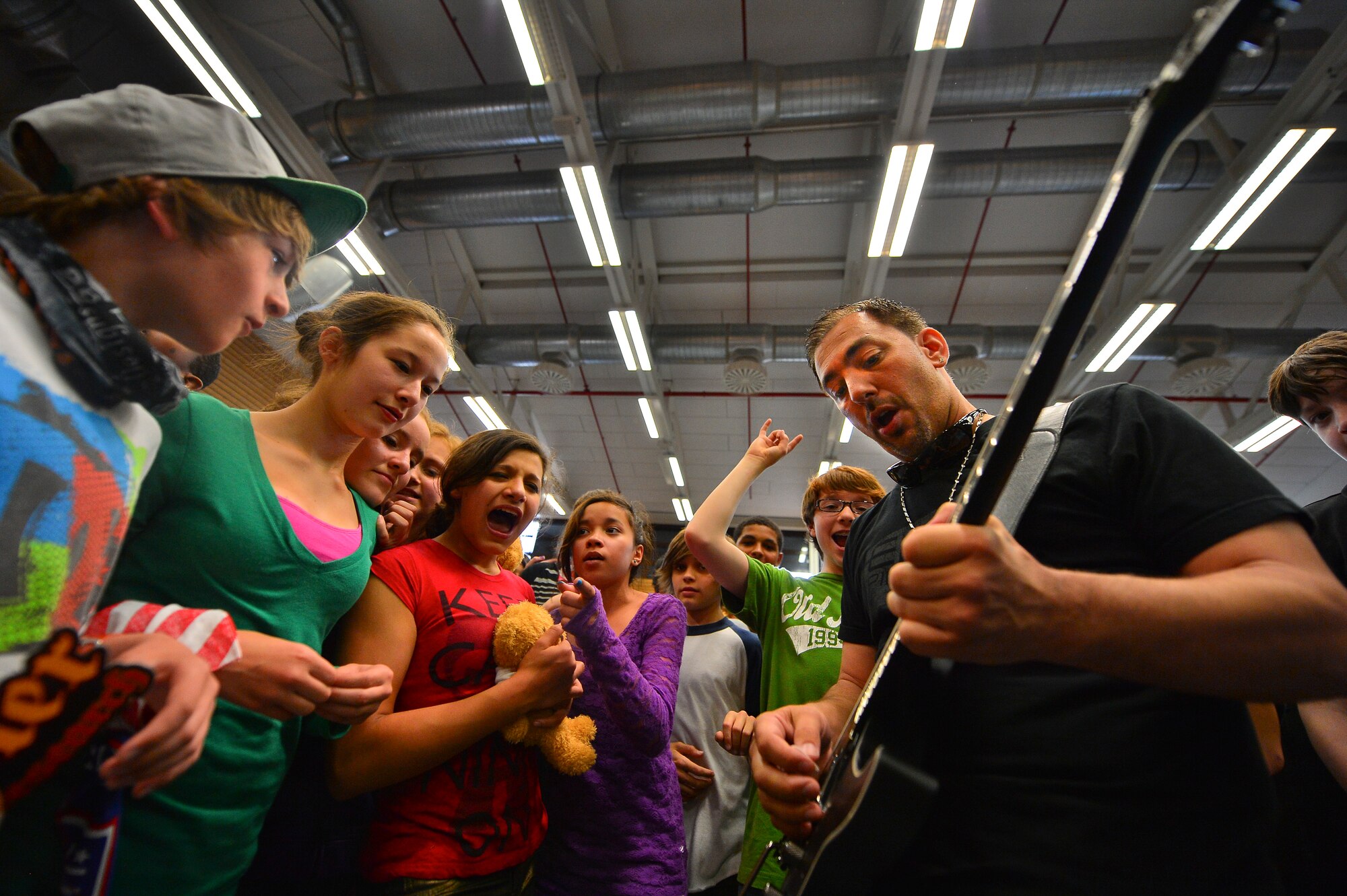 Damon Marks, musician, preforms for students at Ramstein Middle School on Ramstein Air Base, Germany, May 21, 2013. The Traveling Guitar Foundation embarked on its first USO tour of Germany. (U.S. Air Force photo/Airman 1st Class Jordan Castelan)
