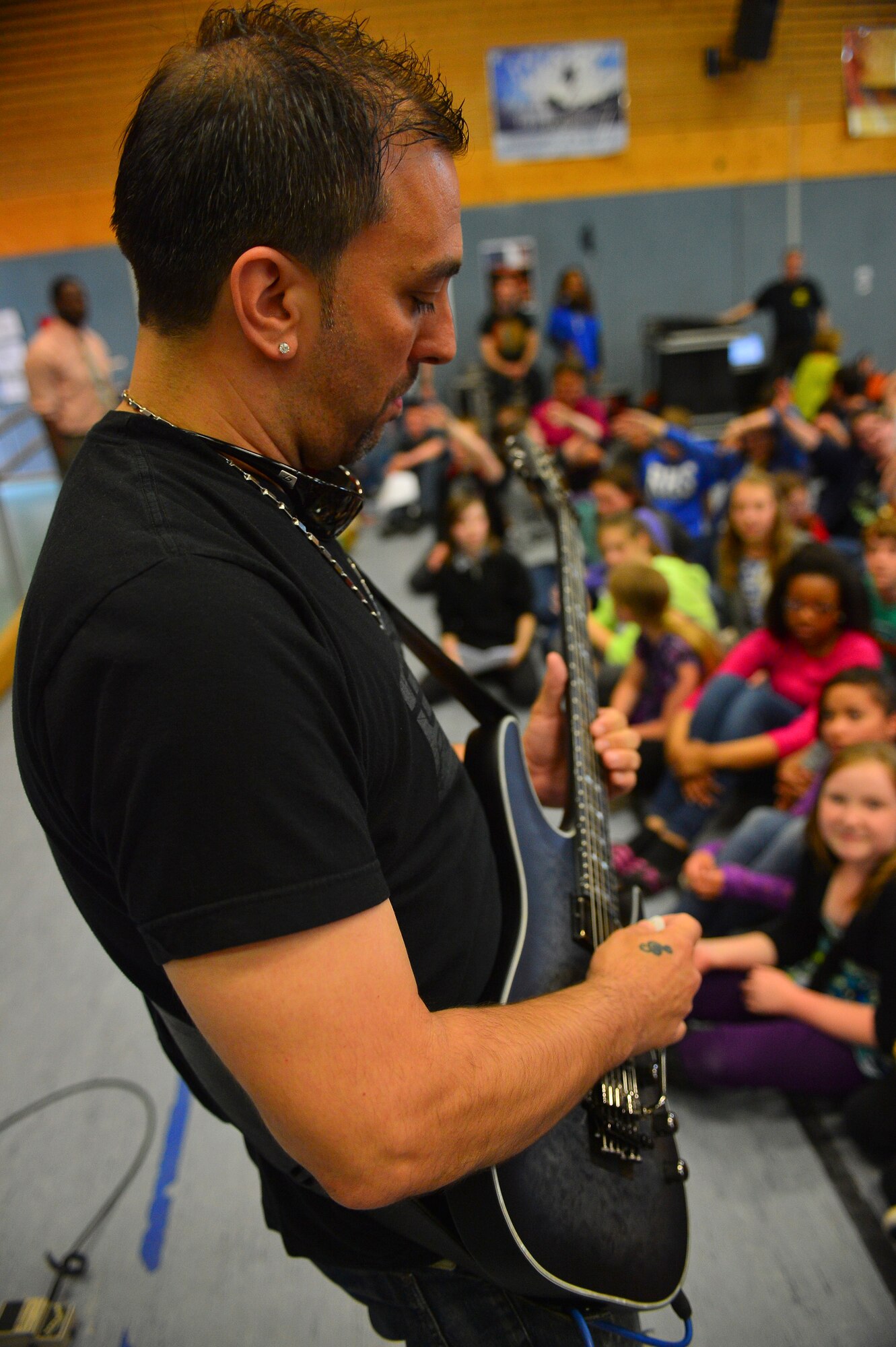 Damon Marks, musician, preforms for students at Ramstein Middle School on Ramstein Air Base, Germany, May 21, 2013. The Traveling Guitar Foundation embarked on its first USO tour of Germany. (U.S. Air Force photo/Airman 1st Class Jordan Castelan)