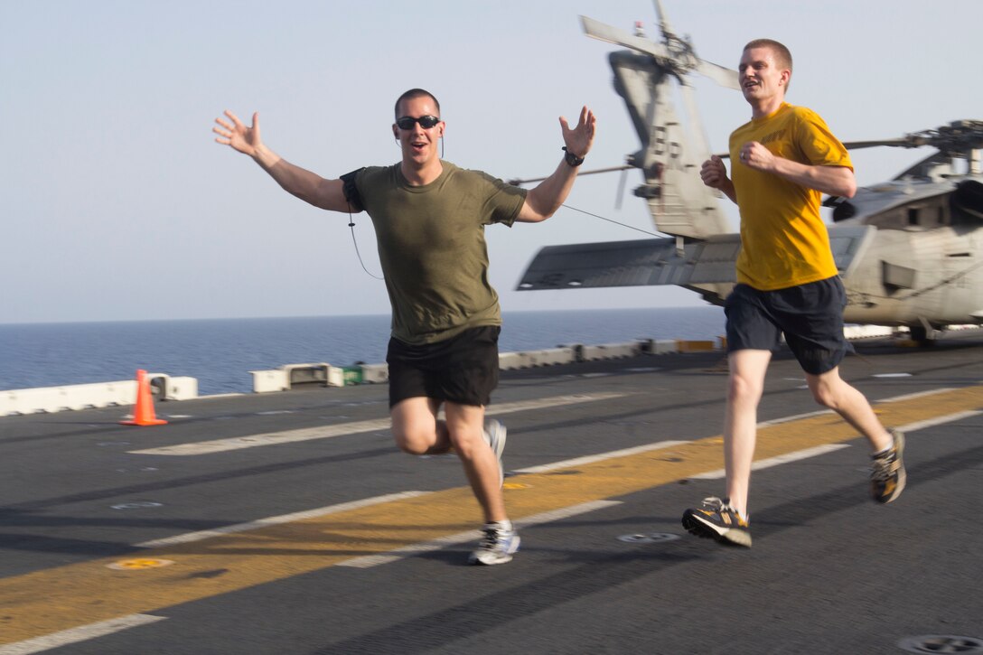 U.S. Marines assigned to the 26th Marine Expeditionary Unit (MEU), and U.S. Sailors assigned to the USS Kearsarge (LHD 3), participate a 5K Run for the Fallen on the flightdeck of the USS Kearsarge at sea, May 25, 2013. The 26th MEU is deployed to the U.S. 5th and 6th Fleet areas of responsibility aboard the Kearsarge Amphibious Ready Group. The 26th MEU operates continuously across the globe, providing the president and unified combatant commanders with a forward-deployed, sea-based quick reaction force. The MEU is a Marine Air-Ground Task Force capable of conducting amphibious operations, crisis response and limited contingency operations. (U.S. Marine Corps photograph by Cpl. Kyle N. Runnels/Released)