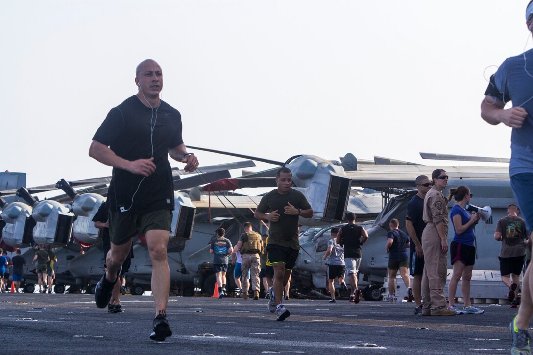 U.S. Marines assigned to the 26th Marine Expeditionary Unit (MEU), and U.S. Sailors assigned to the USS Kearsarge (LHD 3), participate a 5K Run for the Fallen on the flightdeck of the USS Kearsarge at sea, May 25, 2013. The 26th MEU is deployed to the U.S. 5th and 6th Fleet areas of responsibility aboard the Kearsarge Amphibious Ready Group. The 26th MEU operates continuously across the globe, providing the president and unified combatant commanders with a forward-deployed, sea-based quick reaction force. The MEU is a Marine Air-Ground Task Force capable of conducting amphibious operations, crisis response and limited contingency operations. (U.S. Marine Corps photograph by Cpl. Kyle N. Runnels/Released)
