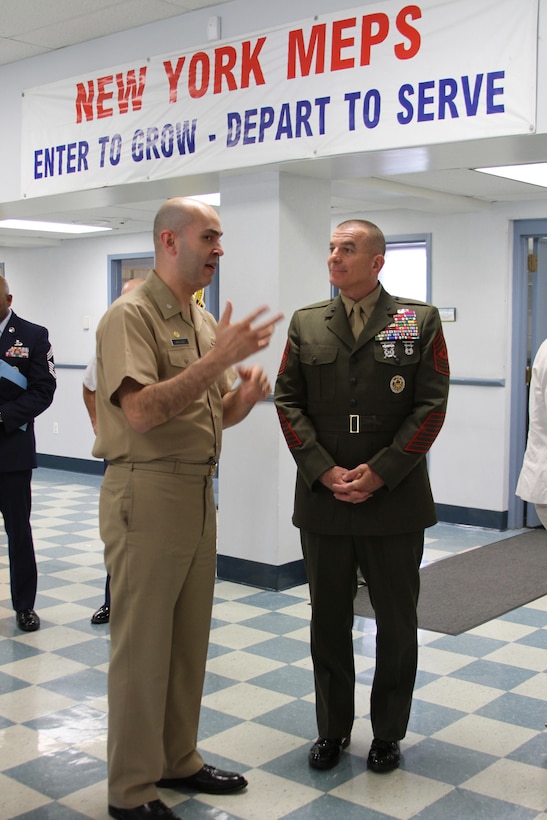 Sgt. Maj. Bryan B. Battaglia, the Senior Enlisted Advisor to Chairman of the Joint Chiefs of Staff, speaks with Cmdr. Jose G. Hernandez, 2nd Battalion commander, before administering the oath of enlistment to a group of applicants at the Military Entrance Processing Station at Fort Hamilton in Brooklyn, N.Y., May 21.  Battaglia visited MEPS while in New York to tour the facility and administer the oath of enlistment to more than 25 military applicants.