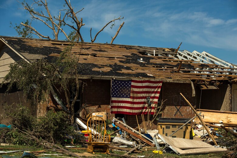 Resident displays an American flag on their home May 22, 2013, in Moore, Okla. An EF-5 tornado, with winds reaching at least 200 mph, traveled for 20 miles, leaving a two-mile-wide path of destruction, leveling homes, crushing vehicles, and killing more than 20 people May 20, 2013. More than 115 Oklahoma National Guard members have been activated to assist in the rescue and relief efforts. (U.S. Air Force photo/ Staff Sgt. Jonathan Snyder) 