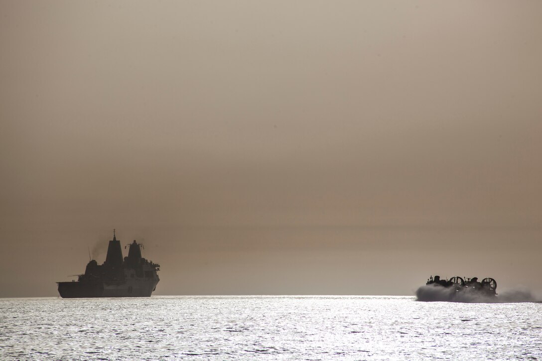A landing craft, air cushion assigned to Assault Craft Unit 4 sails toward the USS San Antonio (LPD 17) in the 5th Fleet Area of Responsibility during International Mine Countermeasure Exercise 13, May 16. IMCMEX is the largest exercise of its kind in the region and will exercise a wide spectrum of defensive operations designed to protect international commerce and trade; mine countermeasures, maritime security operations (MSO) and maritime infrastructure protection (MIP). (U.S. Marine Corps photo by 2nd Lt. Gerard R. Farao/Released)
