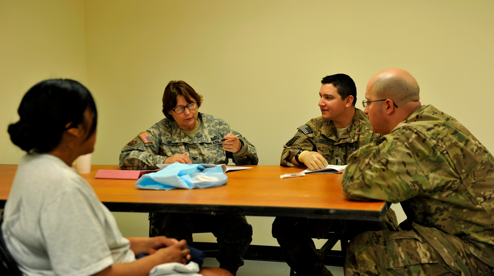 U.S. Army Col. Pauline Gross, Sexual Assault Forensic Examinations instructor, gives feedback to students after conducting a SAFE exam on a simulated patient on Bagram Airfield, Afghanistan, May 25, 2013. The SAFE training equips medical professionals with the skills to conduct a full exam on members who have been sexually assaulted. (U.S. Air Force photo/Staff Sgt. Stephenie Wade)