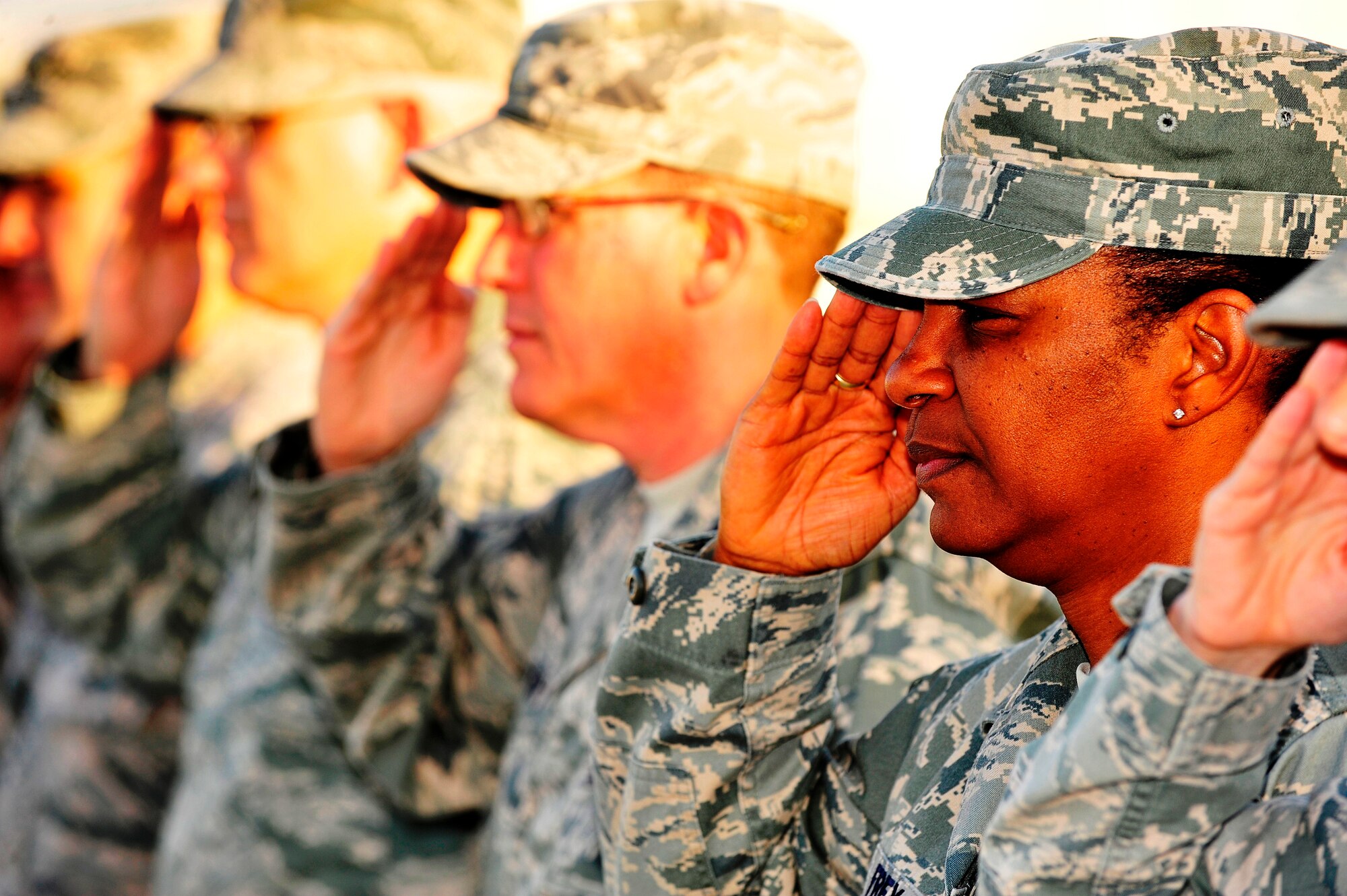 U.S. Air Force Chief Master Sgt. Shelina Frey, 380th Air Expeditionary Wing command chief, salutes the colors during retreat at an undisclosed location in Southwest Asia Feb. 26, 2013. Every Friday the wing performs retreat with special emphasis on the last Friday of the month when names of the Airmen who have fallen in service to their country that month are read aloud and honored. (U.S. Air Force photo by Tech. Sgt. Christina M. Styer/Released)