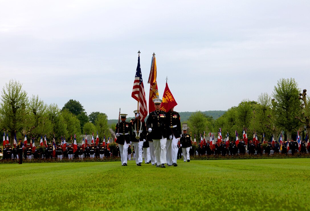 The Marine detachment from the 5th Marine Regiment enters the parade field of Aisne-Marne American Cemetery for the Memorial Day event, May 26. To celebrate Memorial Day, and to mark the 95th anniversary of the historic Battle of Belleau Wood, U.S. Marines with their French counterparts gathered at Aisne-Marne American Cemetery to commemorate their fallen heroes, May 26. The event was held in the memorial cemetery that lies outside of the historic grounds of Belleau Wood and featured the laying of wreathes, a firing of volleys, the playing of TAPS, raising of the American and French national colors, and a concert by the French military band. The mayor of the village of Bellau along with other military officers and officials representing the U.S. and France were present. Participating units from the U.S. Marines included 5th Marine Regiment, Marine Security Guard Detachment, the Wounded Warrior Regiment and Marine Forces Europe and Africa. French units that participated in the ceremony included the 21st Marine Infantry Regiment and the Musique Principale des Troupes de Marines. 
