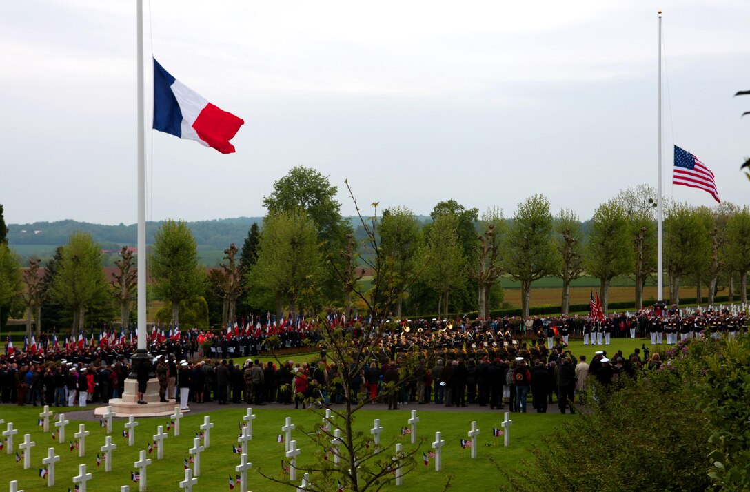 The Memorial Day ceremony at Aisne-Marne American Cemetery as seen from the woods of Belleau, the historic battlegrounds of The Battle of Belleau Wood, May 26. To celebrate Memorial Day, and to mark the 95th anniversary of the historic Battle of Belleau Wood, U.S. Marines with their French counterparts gathered at Aisne-Marne American Cemetery to commemorate their fallen heroes, May 26. The event was held in the memorial cemetery that lies outside of the historic grounds of Belleau Wood and featured the laying of wreathes, a firing of volleys, the playing of TAPS, raising of the American and French national colors, and a concert by the French military band. The mayor of the village of Bellau along with other military officers and officials representing the U.S. and France were present. Participating units from the U.S. Marines included 5th Marine Regiment, Marine Security Guard Detachment, the Wounded Warrior Regiment and Marine Forces Europe and Africa. French units that participated in the ceremony included the 21st Marine Infantry Regiment and the Musique Principale des Troupes de Marines. 
