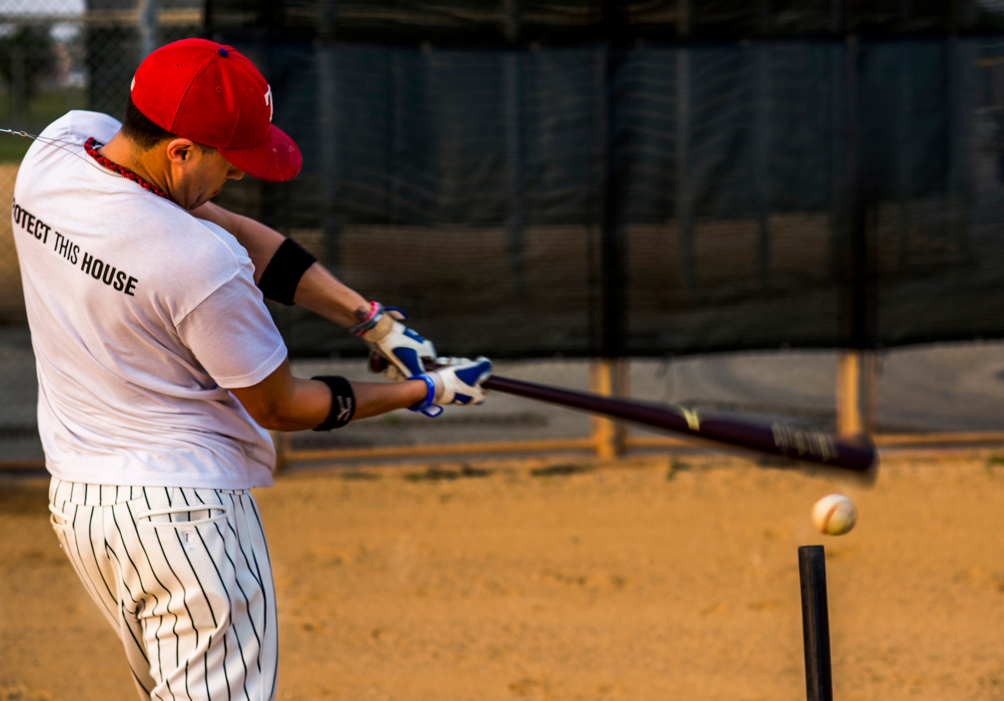 U.S. Air Force Senior Airman Cody Hyde, 18th Dental Squadron dental technician, hits off a tee during batting practice at Kadena Air Base, May 23, 2013. Hyde was invited to try out for the Armed Forces Baseball Team at the training camp May 29-June 8. If he makes the team he will travel across the United States, playing baseball and interacting with communities across the country. (U.S. Air Force photo/Airman 1st Class Tyler Prince.) 