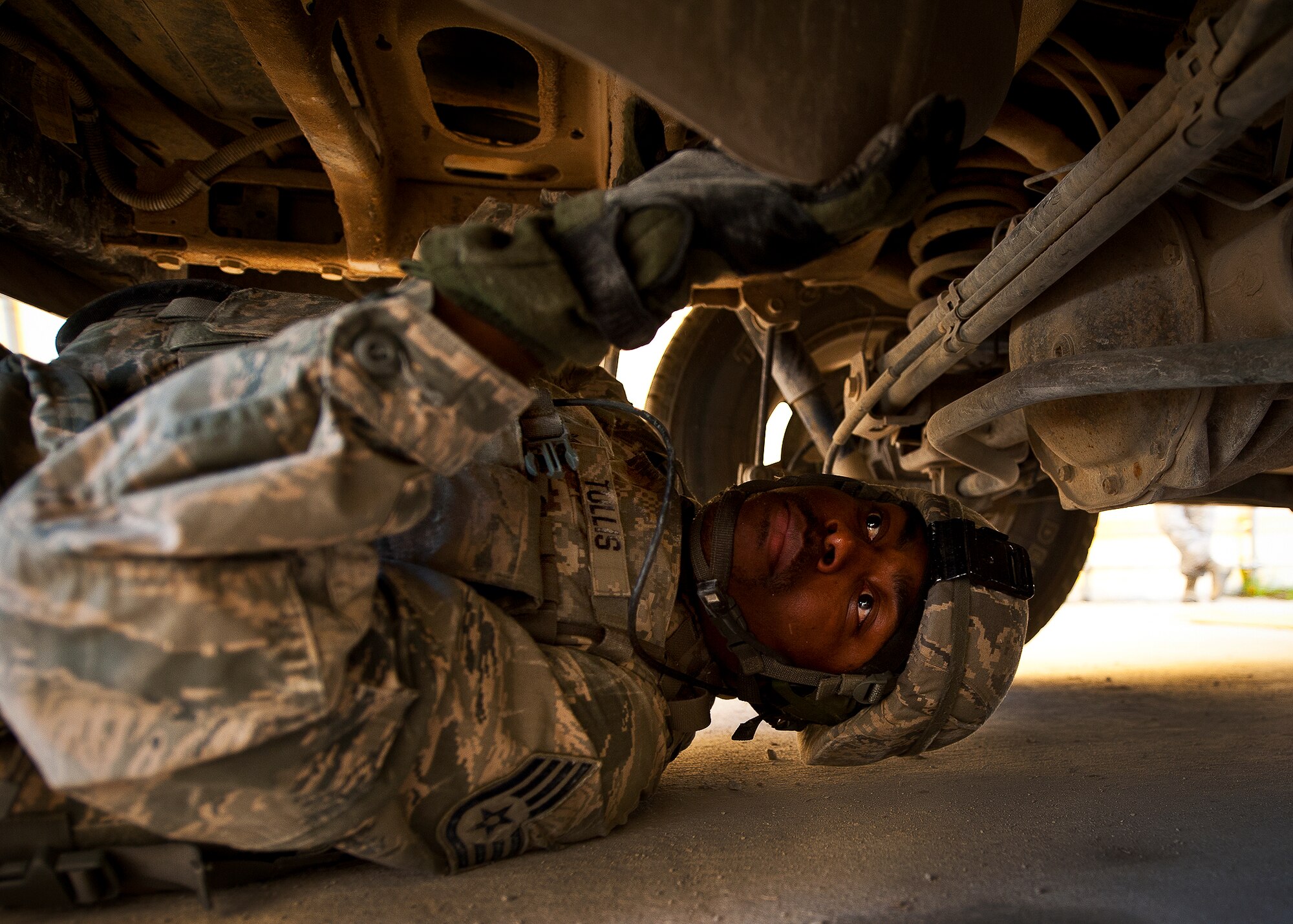 Staff Sgt. Darrin Tullis, of the 30th Security Forces Squadron, checks underneath the SUV as part of Base Tango’s entry control point vehicle inspections during the three-day Brave Defender field training exercise May 20 at Eglin Air Force Base, Fla.  The exercise is the culmination of Air Force Materiel Command’s six-week security forces deployment training, administered by the 96th Ground Combat Training Squadron. GCTS instructors teach 10 training classes a year, which consists of improvised explosive device detection and reaction, operating in an urban environment, mission planning, land navigation and casualty care and more. More than 140 active-duty and National Guard Airmen attended this training. (U.S. Air Force photo/Samuel King Jr.)