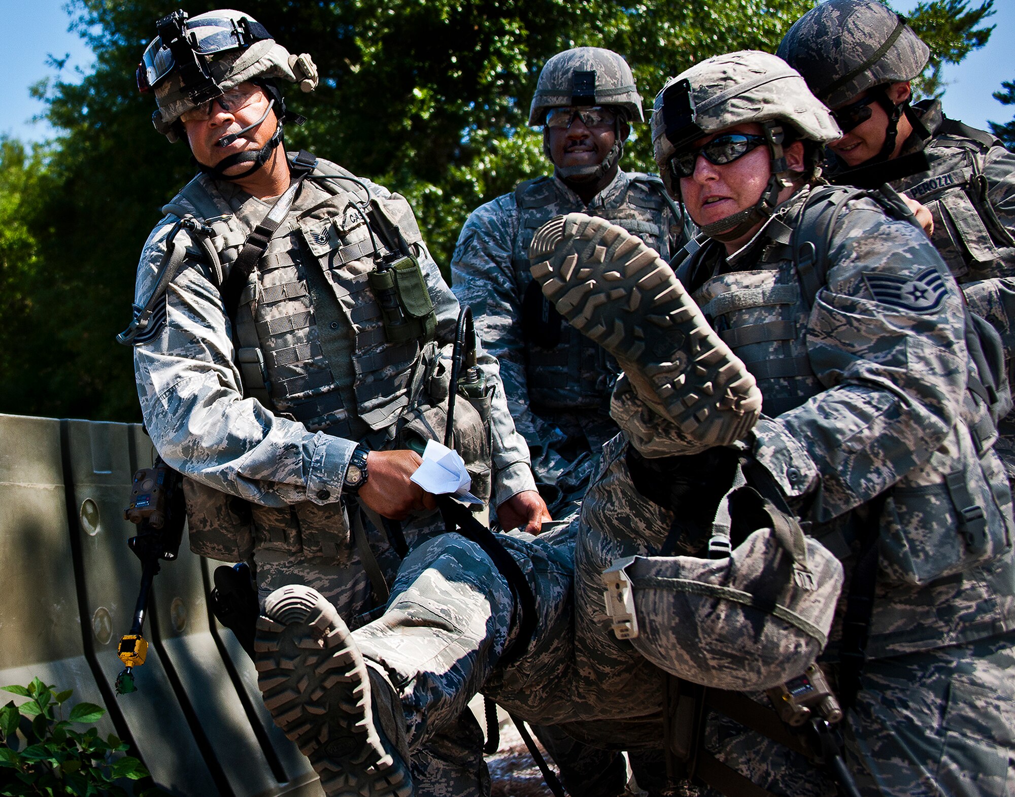 A quick response force fire-team carries a wounded Airman to safety after an attack at the Base Tango entry control point during the three-day Brave Defender field training exercise May 20 at Eglin Air Force Base, Fla.  The exercise is the culmination of Air Force Materiel Command’s six-week security forces deployment training, administered by the 96th Ground Combat Training Squadron. GCTS instructors teach 10 training classes a year, which consists of improvised explosive device detection and reaction, operating in an urban environment, mission planning, land navigation and casualty care and more. More than 140 active-duty and National Guard Airmen attended this training. (U.S. Air Force photo/Samuel King Jr.)