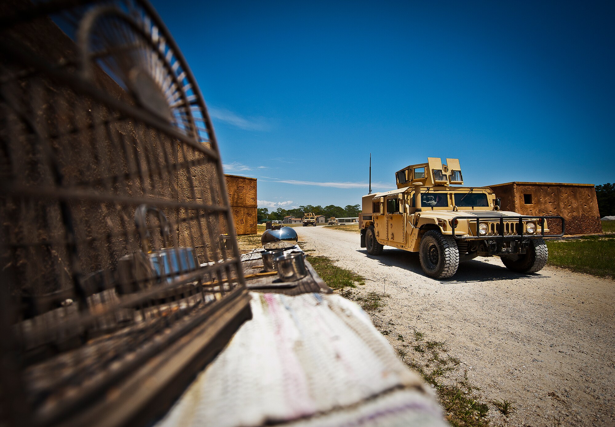 A HMMWV patrol rolls through a village outside of Base Tango during the three-day Brave Defender field training exercise May 20 at Eglin Air Force Base, Fla.  The exercise is the culmination of Air Force Materiel Command’s six-week security forces deployment training, administered by the 96th Ground Combat Training Squadron. GCTS instructors teach 10 training classes a year, which consists of improvised explosive device detection and reaction, operating in an urban environment, mission planning, land navigation and casualty care and more. More than 140 active-duty and National Guard Airmen attended this training. (U.S. Air Force photo/Samuel King Jr.)
