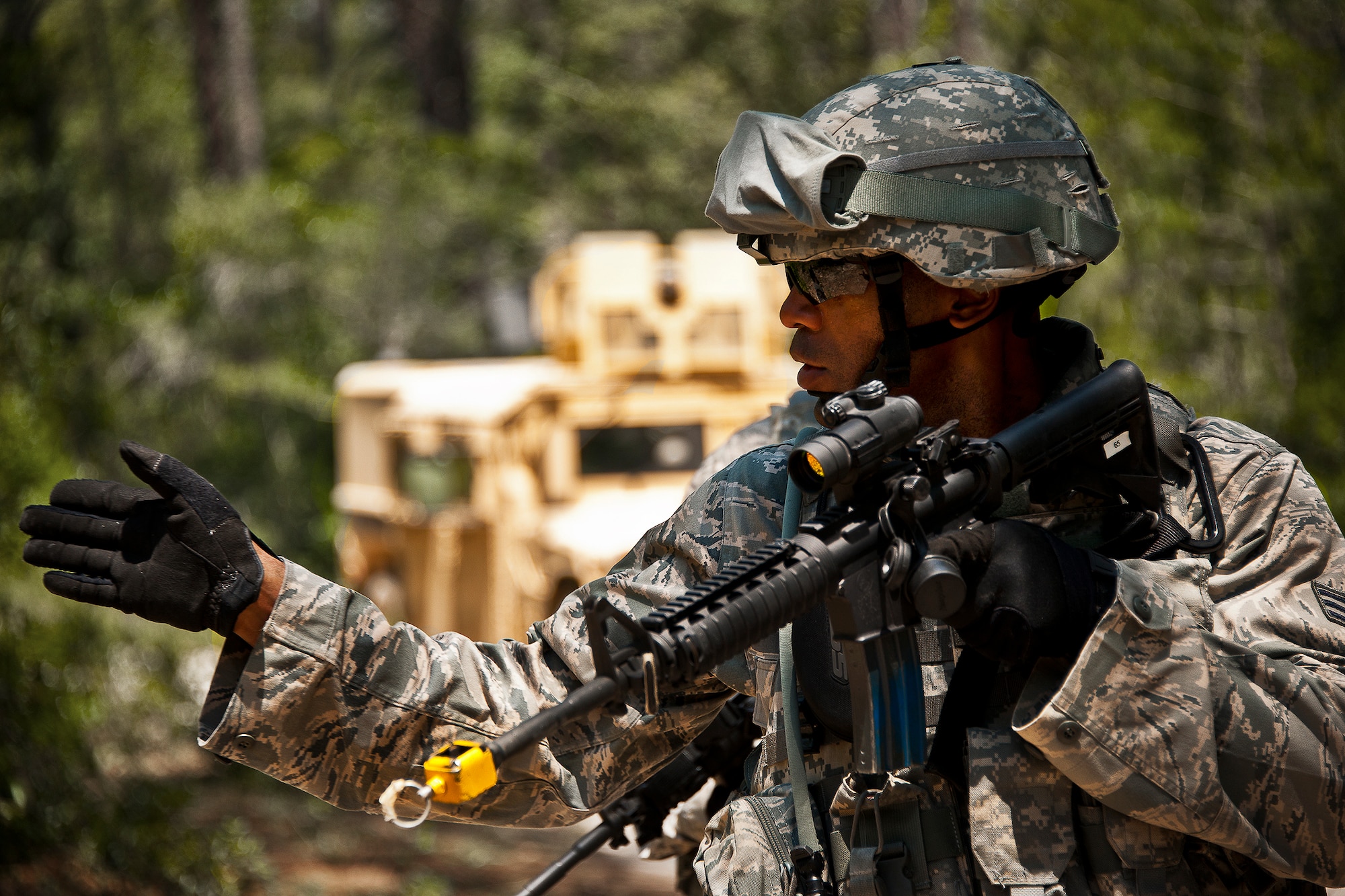 Senior Airman William Whitlow, of the 164th Security Forces Squadron, gives a command during a road check as part of a HMMWV patrol mission during the three-day Brave Defender field training exercise May 20 at Eglin Air Force Base, Fla.  The exercise is the culmination of Air Force Materiel Command’s six-week security forces deployment training, administered by the 96th Ground Combat Training Squadron. GCTS instructors teach 10 training classes a year, which consists of improvised explosive device detection and reaction, operating in an urban environment, mission planning, land navigation and casualty care and more. More than 140 active-duty and National Guard Airmen attended this training. (U.S. Air Force photo/Samuel King Jr.)