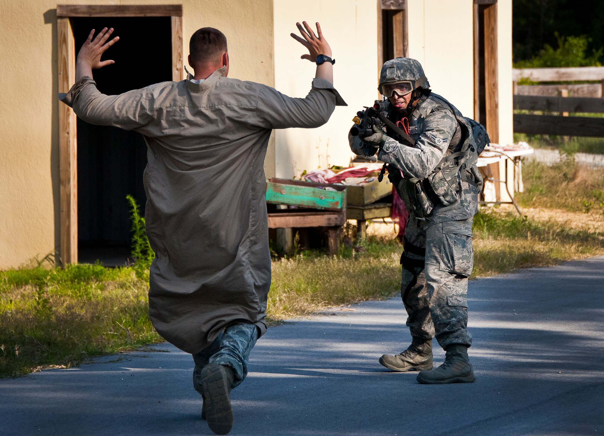 Airman 1st Class Christian Aviles, of the 30th Security Forces Squadron, stops the fleeing high value target after an assault on a village at the end of the three-day Brave Defender field training exercise May 20 at Eglin Air Force Base, Fla.  The exercise is the culmination of Air Force Materiel Command’s six-week security forces deployment training, administered by the 96th Ground Combat Training Squadron. GCTS instructors teach 10 training classes a year, which consists of improvised explosive device detection and reaction, operating in an urban environment, mission planning, land navigation and casualty care and more. More than 140 active-duty and National Guard Airmen attended this training. (U.S. Air Force photo/Samuel King Jr.)