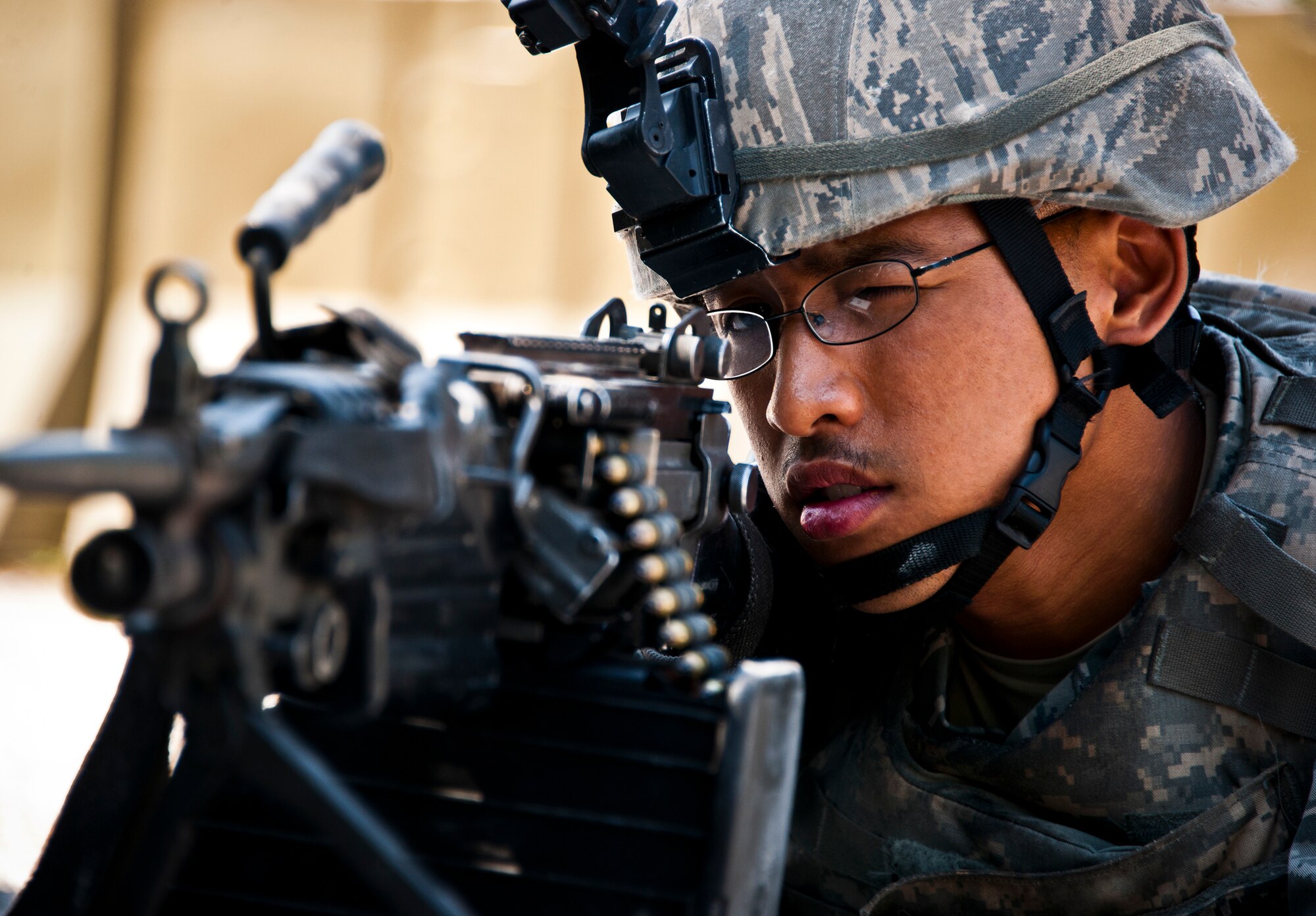 Senior Airman Ruel Pangilinan, from the 30th Security Forces Squadron, aims his M-249 downrange after an enemy assault on the base during the three-day Brave Defender field training exercise May 20 at Eglin Air Force Base, Fla.  The exercise is the culmination of Air Force Materiel Command’s six-week security forces deployment training, administered by the 96th Ground Combat Training Squadron. GCTS instructors teach 10 training classes a year, which consists of improvised explosive device detection and reaction, operating in an urban environment, mission planning, land navigation and casualty care and more. More than 140 active-duty and National Guard Airmen attended this training. (U.S. Air Force photo/Samuel King Jr.)