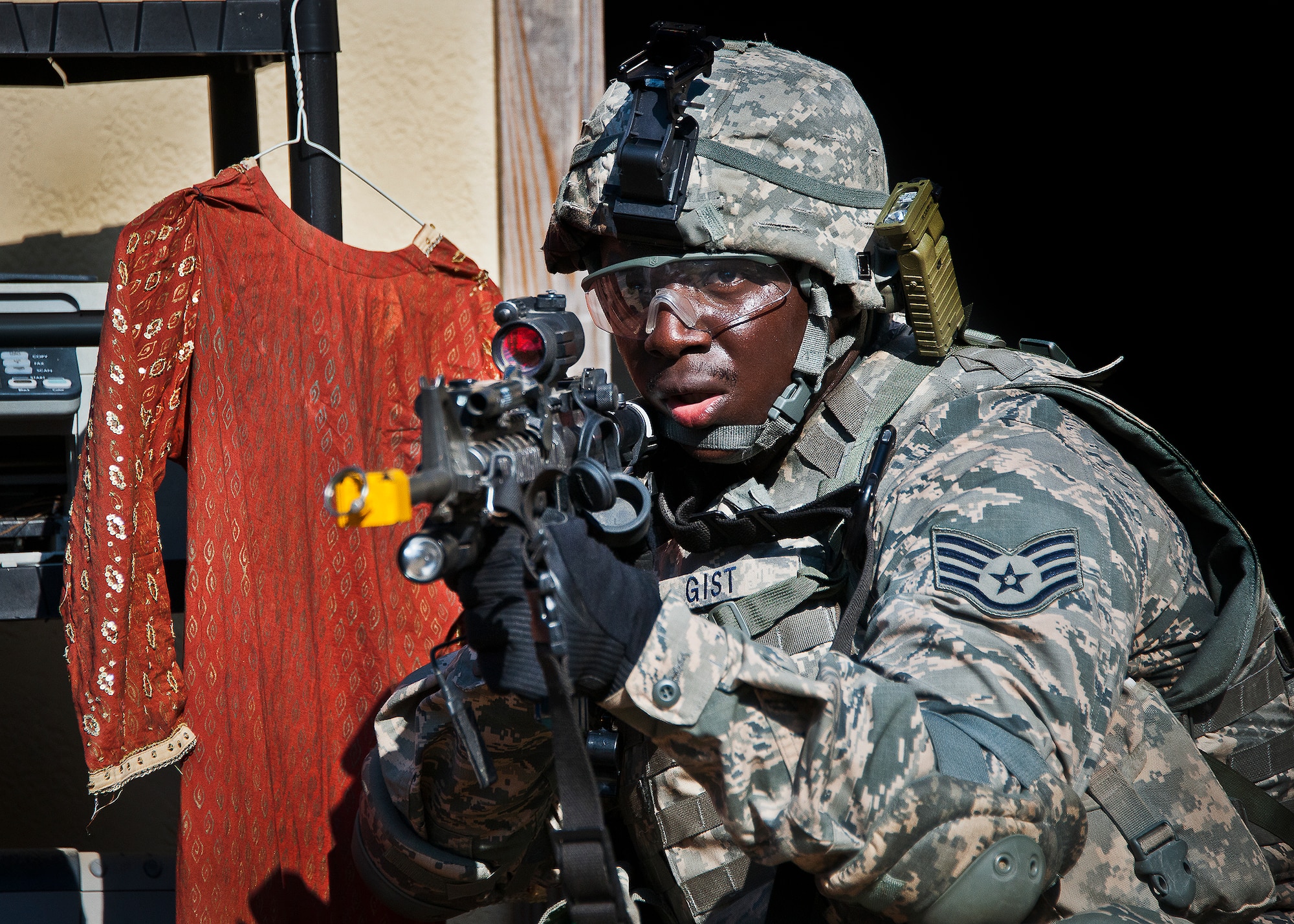 Staff Sgt. Anthony Gist, of the 802nd Security Forces Squadron, waits for his fire team before advancing during a village assault during the three-day Brave Defender field training exercise May 20 at Eglin Air Force Base, Fla.  The exercise is the culmination of Air Force Materiel Command’s six-week security forces deployment training, administered by the 96th Ground Combat Training Squadron. GCTS instructors teach 10 training classes a year, which consists of improvised explosive device detection and reaction, operating in an urban environment, mission planning, land navigation and casualty care and more. More than 140 active-duty and National Guard Airmen attended this training. (U.S. Air Force photo/Samuel King Jr.)