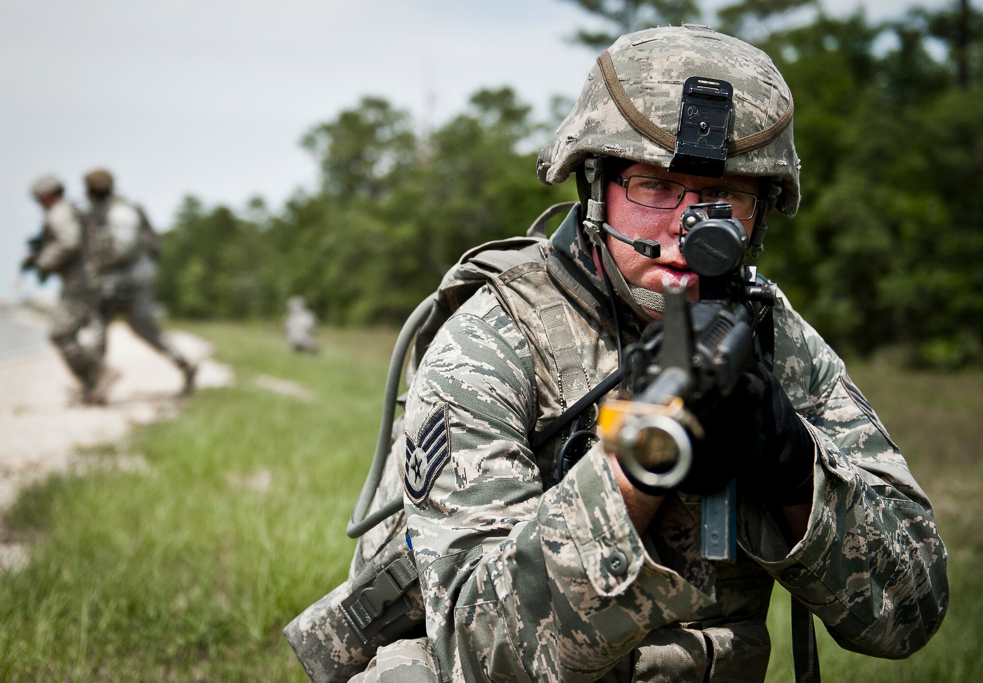 A security forces staff sergeant watches for attacks as his patrol crosses a road during a dismounted mission as part of the three-day Brave Defender field training exercise May 19 at Eglin Air Force Base, Fla.  The exercise is the culmination of Air Force Materiel Command’s six-week security forces deployment training, administered by the 96th Ground Combat Training Squadron. GCTS instructors teach 10 training classes a year, which consists of improvised explosive device detection and reaction, operating in an urban environment, mission planning, land navigation and casualty care and more. More than 140 active-duty and National Guard Airmen attended this training. (U.S. Air Force photo/Samuel King Jr.)