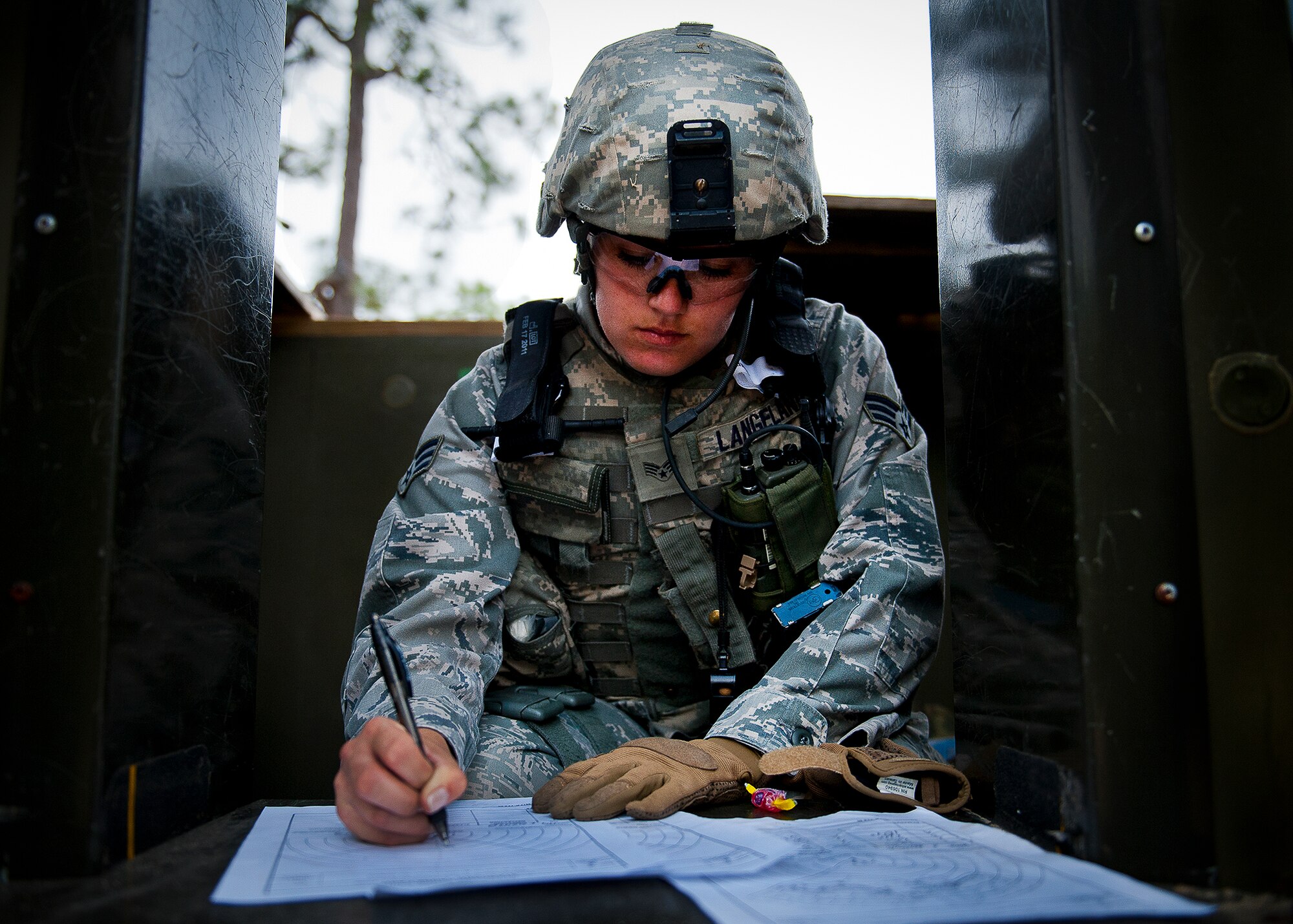 Senior Airman Mariah Langeland, of the 56th Security Forces Squadron, fills out her range card from her post in one of the guard towers along the wall of Base Tango during the three-day Brave Defender field training exercise May 19 at Eglin Air Force Base, Fla.  The exercise is the culmination of Air Force Materiel Command’s six-week security forces deployment training, administered by the 96th Ground Combat Training Squadron. GCTS instructors teach 10 training classes a year, which consists of improvised explosive device detection and reaction, operating in an urban environment, mission planning, land navigation and casualty care and more. More than 140 active-duty and National Guard Airmen attended this training. (U.S. Air Force photo/Samuel King Jr.)