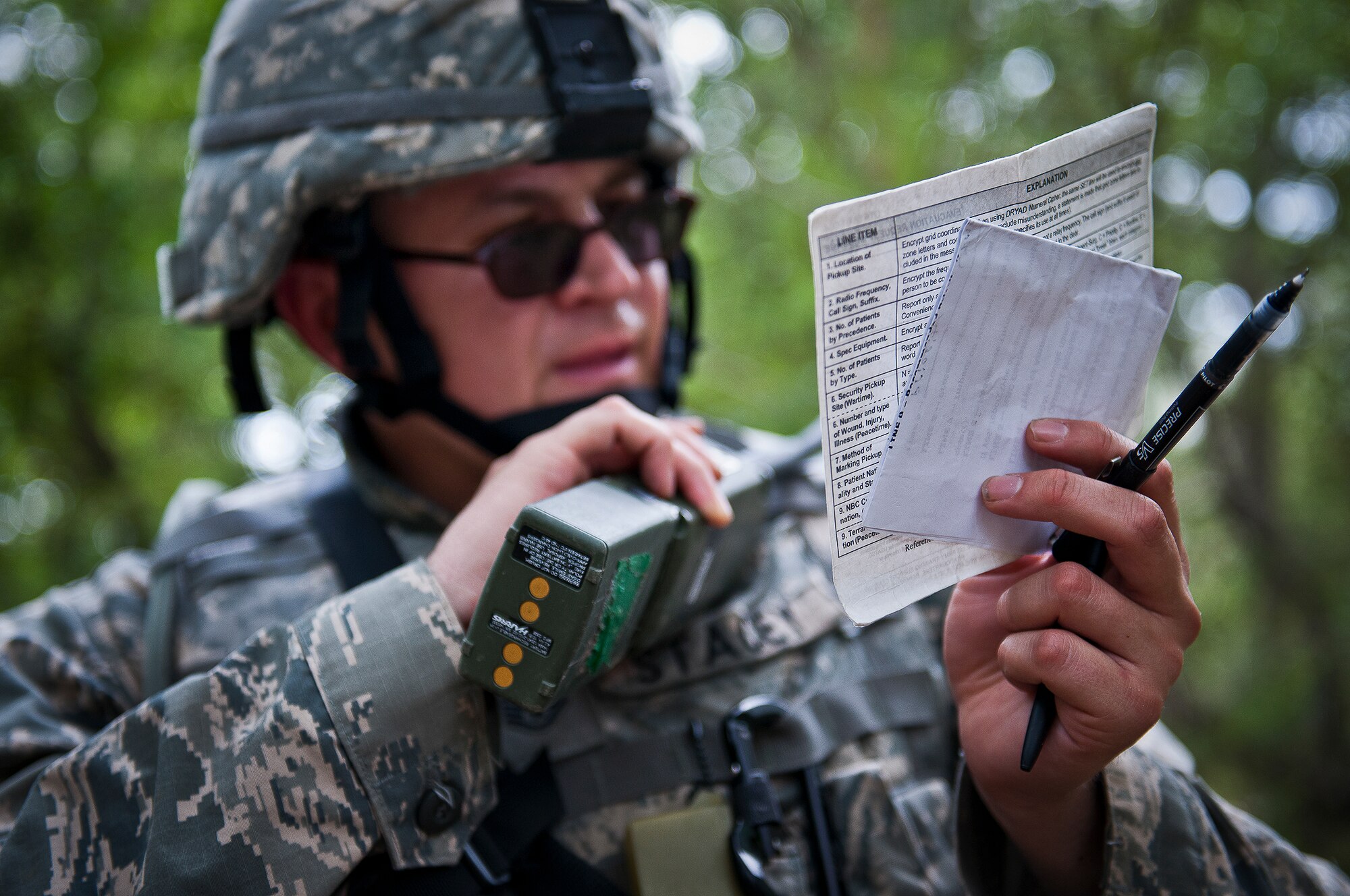 Staff Sgt. James Stacey, of the 164th Security Forces Squdron reports an injury via a nine-line after a fire-fight while on a dismounted patrol during the three-day Brave Defender field training exercise May 19 at Eglin Air Force Base, Fla.  The exercise is the culmination of Air Force Materiel Command’s six-week security forces deployment training, administered by the 96th Ground Combat Training Squadron. GCTS instructors teach 10 training classes a year, which consists of improvised explosive device detection and reaction, operating in an urban environment, mission planning, land navigation and casualty care and more. More than 140 active-duty and National Guard Airmen attended this training. (U.S. Air Force photo/Samuel King Jr.)