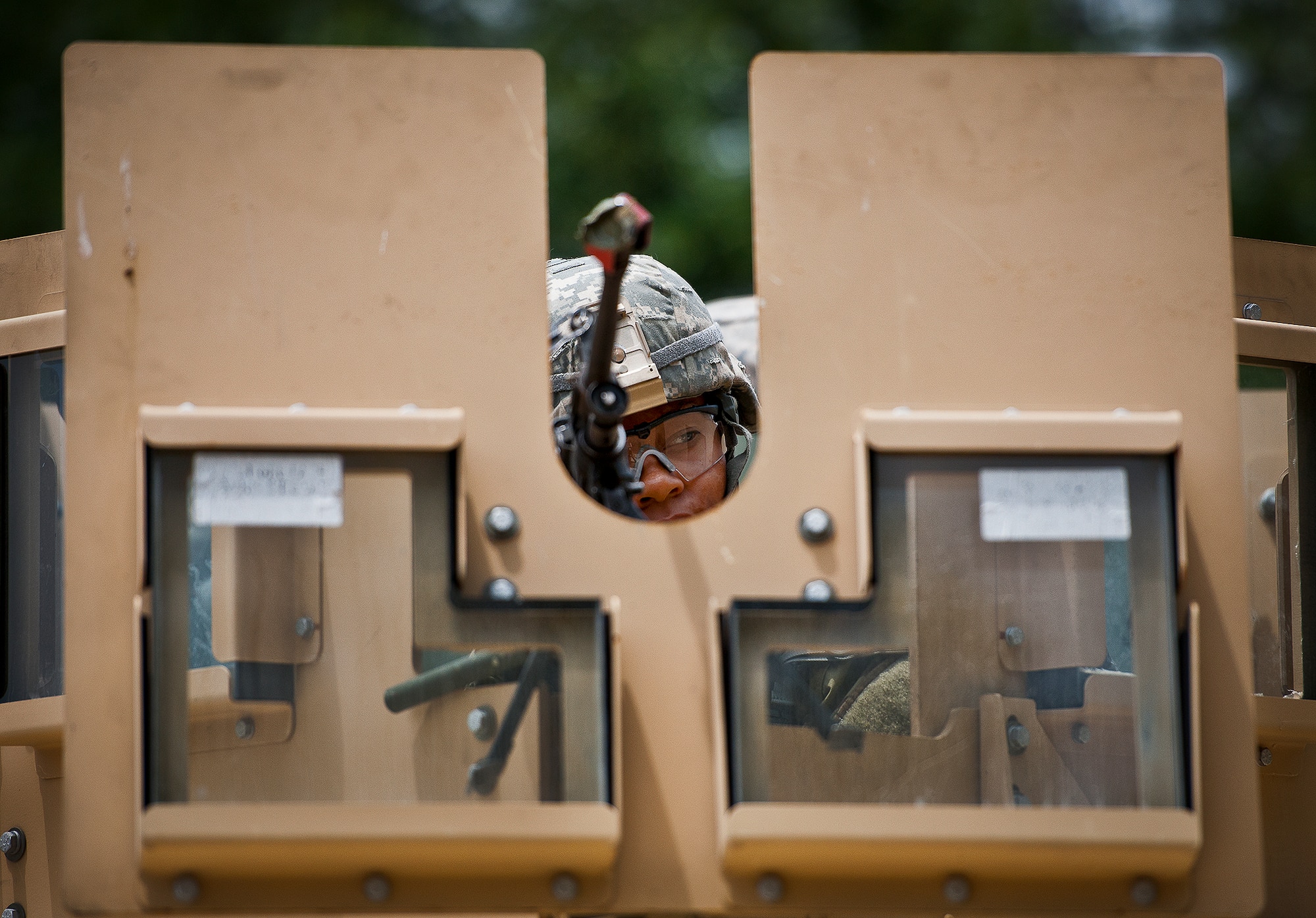 Senior Airman Sheena Jeter, of the 94th Security Forces Squadron, looks around from inside the armored turret of her HMMWV during the three-day Brave Defender field training exercise May 19 at Eglin Air Force Base, Fla.  The exercise is the culmination of Air Force Materiel Command’s six-week security forces deployment training, administered by the 96th Ground Combat Training Squadron. GCTS instructors teach 10 training classes a year, which consists of improvised explosive device detection and reaction, operating in an urban environment, mission planning, land navigation and casualty care and more. More than 140 active-duty and National Guard Airmen attended this training. (U.S. Air Force photo/Samuel King Jr.)