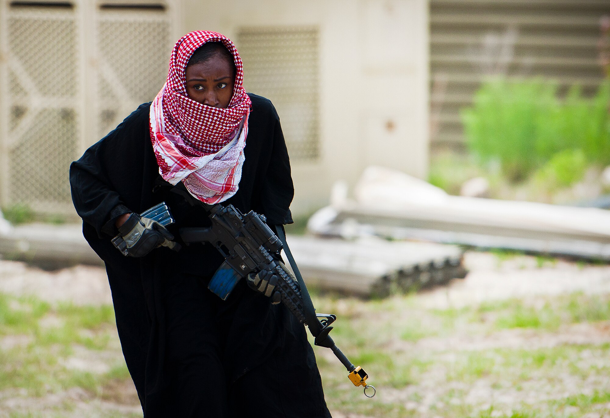 Staff Sgt. Evelyn Nunez moves in during an enemy assault on the base at the three-day Brave Defender field training exercise May 19 at Eglin Air Force Base, Fla.  Nunez and other enemy role players attacked the entry control point and moved in to the base.  The exercise was to see how base leadership and the quick response forces responded.  The exercise is the culmination of Air Force Materiel Command’s six-week security forces deployment training, administered by the 96th Ground Combat Training Squadron. GCTS instructors teach 10 training classes a year, which consists of improvised explosive device detection and reaction, operating in an urban environment, mission planning, land navigation and casualty care and more. More than 140 active-duty and National Guard Airmen attended this training. (U.S. Air Force photo/Samuel King Jr.)