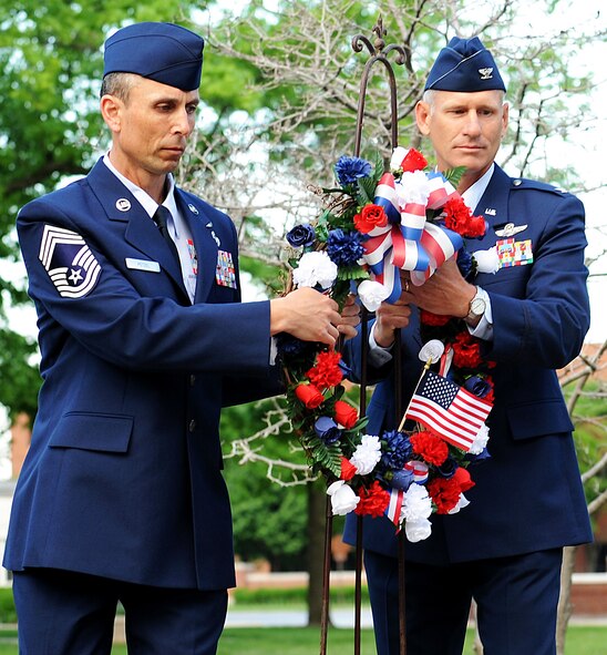 Col. David Almand, 375th Air Mobility Wing commander and Chief Master Sgt. Todd Petzel, 375th Air Mobility Wing acting command chief, place a wreath at the base of the flag pole during a Memorial Day Remembrance event held at the 375th Air Mobility Wing headquarters building May 27, 2013. On June 28, 1968, Congress passed the Uniform Monday Holiday Act, which moved four holidays. Memorial Day was thus moved from its traditional May 30 date to the last Monday in May. (U.S. Air Force photo/Staff Sgt. Teresa M. Jennings)