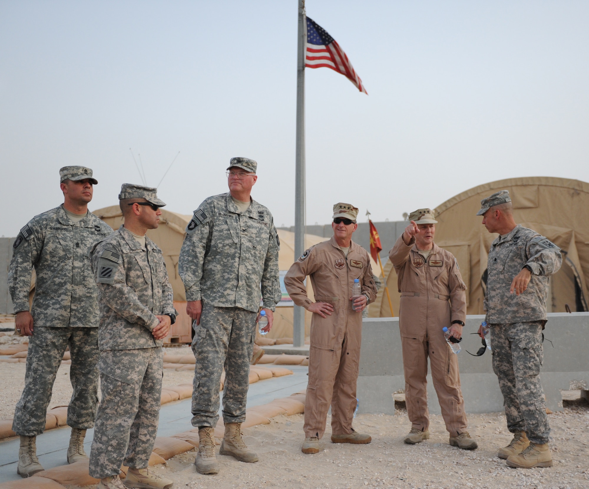 Lt. Gens. David L. Goldfein and John W. Hesterman visit the 1-43 Air Defense Artillery Battalion's active Patriot site May 22, 2013, at the 379th Air Expeditionary Wing in Southwest Asia. While on site, the 69th ADA Brigade commander, Col. Randall A. McIntire, and 1-43 ADA BN commander, Lt. Col. David E. Shank, gave the generals a personal tour of the site while the battery conducted a training exercise simulating the Patriot site preparing to move from one site to emplace on another. This exercise and others like it ensure soldiers are trained and ready to deal with any real-world threats that may arise. (U.S. Army photo/Capt. Steven Modugno)