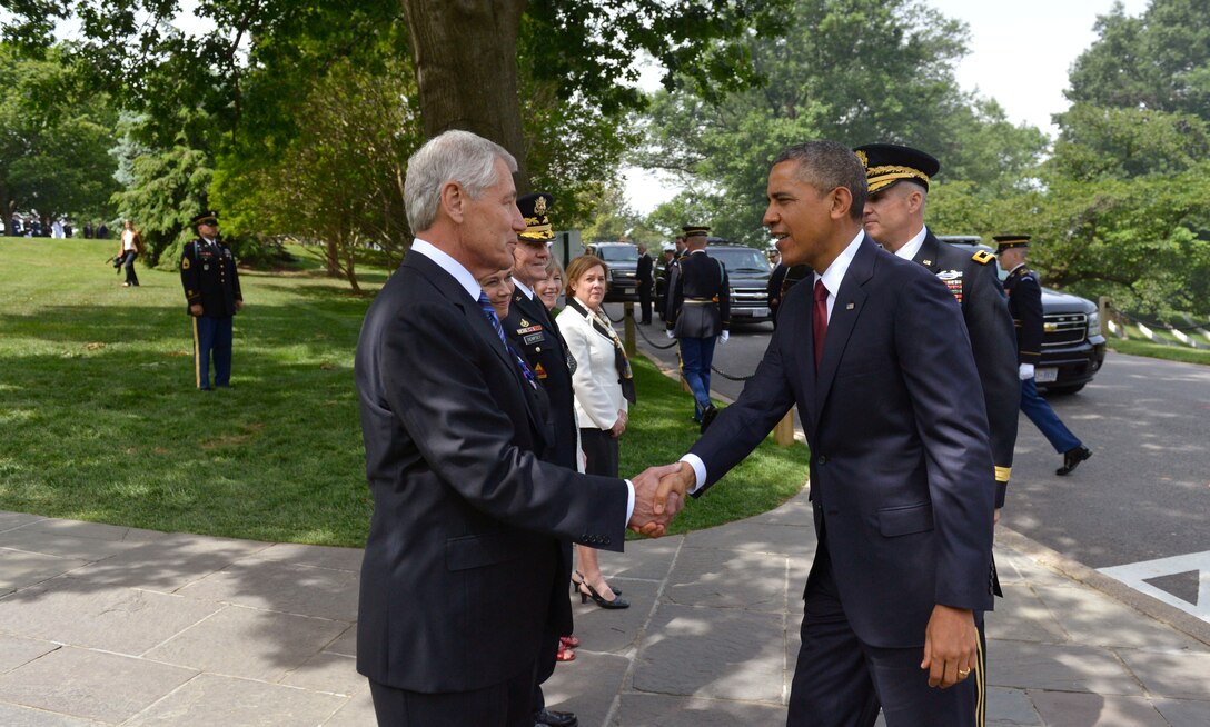 Defense Secretary Chuck Hagel shakes hands with President Barack Obama as he arrives to join Hagel in honoring the nation's fallen service members during the annual Memorial Day observance at Arlington National Cemetery, Va., May 27, 2013.