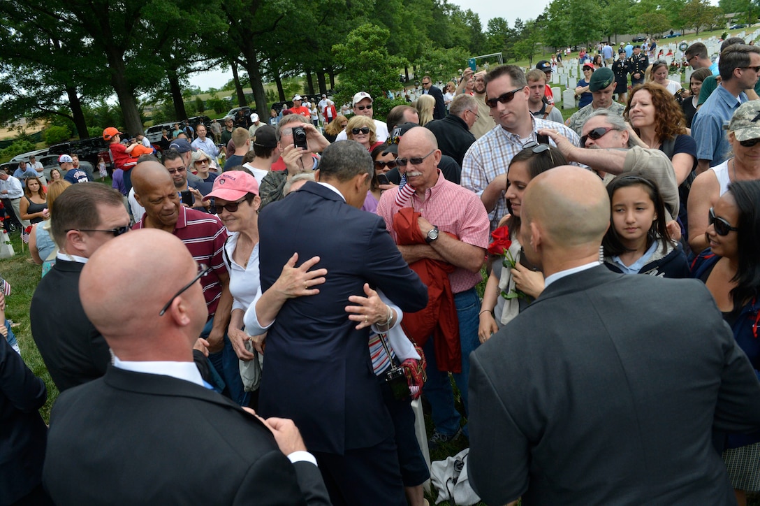 President Barack Obama hugs a grieving family member in Section 60 during the 145th annual Memorial Day observance at Arlington National Cemetery, Va., May 27, 2013. U.S. service members who died during the wars in Iraq and Afghanistan are buried in that section.