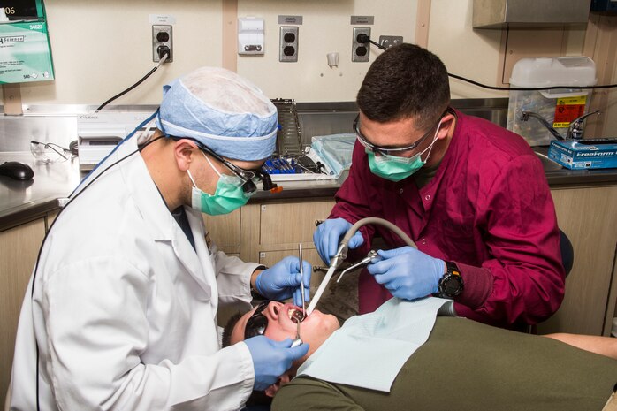 U.S. Navy Hospitalman Justin Sobleskie (right), line corpsman from Severn, Md., assigned to Company K, Battalion Landing Team (BLT) 3/2, 26th Marine Expeditionary Unit (MEU), and U.S. Navy Lt. Matthew Roberts, USS Carter Hall dental department head from Nantucket, Mass., do dental work on Hospitalman 3rd Class Shane Murphy, line corpsman from Spokane, Wash., with Tank Platoon, BLT 3/2, 26th MEU, aboard the USS Carter Hall (LSD 50) while at sea May 26, 2013. The 26th MEU is a Marine Air-Ground Task Force forward-deployed to the U.S. 5th Fleet area of responsibility aboard the Kearsarge Amphibious Ready Group serving as a sea-based, expeditionary crisis response force capable of conducting amphibious operations across the full range of military operations.
(U.S. Marine Corps photo by Cpl. Michael S. Lockett/Released)