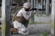 A Marine attached to Combat Logistics Battalion 6, 2nd Marine Logistics Group prepares to fire an M-1014 Joint Service Combat Shotgun from the kneeling position during a shotgun qualification aboard Camp Lejeune, N.C., May 22, 2013. The Marines practiced shooting shotguns from multiple distances and firing positions to inspire confidence in their ability to use the weapons in different situations. 