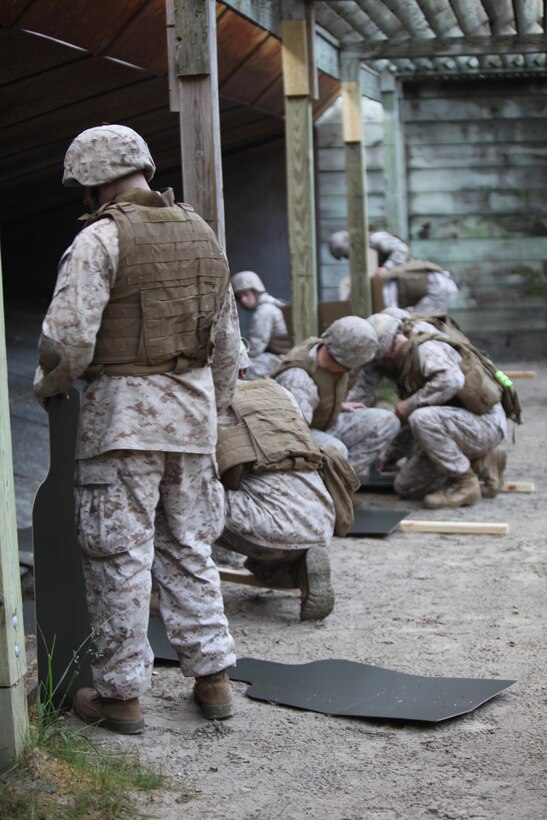 Service members attached to Combat Logistics Battalion 6, 2nd Marine Logistics Group set up fresh targets after training with M-1014 Joint Service Combat Shotguns during a shotgun qualification aboard Camp Lejeune, N.C., May 22, 2013. Each Marine practiced loading and firing procedures in order to prepare for ammunition guard duty during an upcoming deployment.