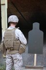 A service member attached to Combat Logistics Battalion 6, 2nd Marine Logistics Group reviews his shots on a target during a shotgun qualification aboard Camp Lejeune, N.C., May 22, 2013. The Marines trained to use M-1014 Joint Service Combat Shotguns to defend ammunition supply points on future deployments. 