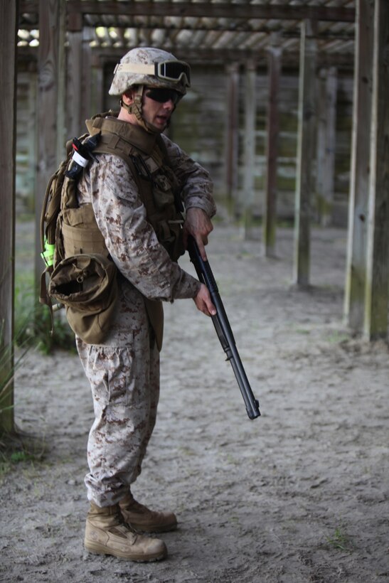 Staff Sgt. Joseph J. Giacomelli, an ammunition technician with Ammunition Company, 2nd Supply Battalion, 2nd Marine Logistics Group, demonstrates proper loading procedures for the M-1014 Joint Service Combat Shotgun during a shotgun qualification aboard Camp Lejeune, N.C., May 22, 2013. Giacomelli served as the primary marksman instructor for Marines attached to Combat Logistics Battalion 6, 2nd MLG, who underwent training with the shotguns in preparation for an upcoming deployment.
