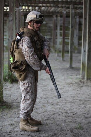 Staff Sgt. Joseph J. Giacomelli, an ammunition technician with Ammunition Company, 2nd Supply Battalion, 2nd Marine Logistics Group, demonstrates proper loading procedures for the M-1014 Joint Service Combat Shotgun during a shotgun qualification aboard Camp Lejeune, N.C., May 22, 2013. Giacomelli served as the primary marksman instructor for Marines attached to Combat Logistics Battalion 6, 2nd MLG, who underwent training with the shotguns in preparation for an upcoming deployment.