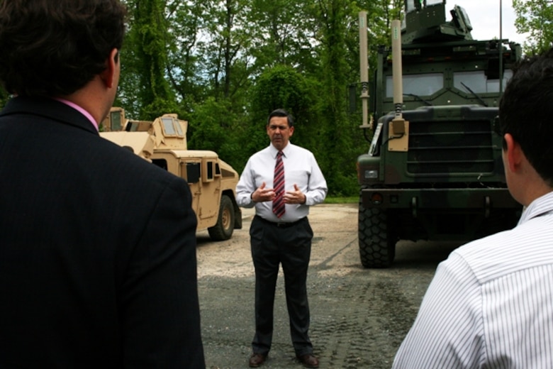 Ruben Garza, Transportation Demonstration Support Area manager,  a TDSA overview briefing to members of the Small Business Administration and Marines participating in the “Boots to Business” program during a visit May 9 in Quantico, Va. The group visited TDSA to view static displays of several Marine Corps vehicle platforms.