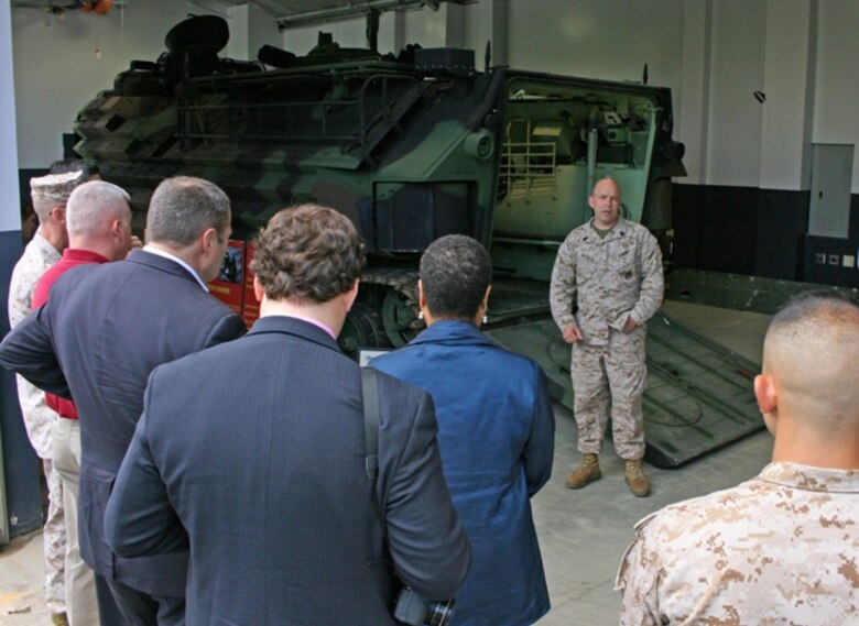 Gunnery Sgt. Kevin Wallace, subject matter expert with the Program Management Office for Advanced Amphibious Assault, talks to a group of visitors about the Assault Amphibious Vehicle at the Transportation Demonstration Support Area May 9 in Quantico, Va. Members of the Small Business Administration and Marines participating in the “Boots to Business” program visited TDSA to view static displays of several Marine Corps vehicle platforms.