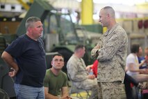 Lt. Col. Craig C. Clemans (right), the commanding officer of 2nd Maintenance Battalion, Combat Logistics Regiment 25, 2nd Marine Logistics Group, speaks with family members of service members with Retrograde and Redeployment in support of Reset and Reconstitution Operations Group, or R4OG, 2nd MLG aboard Camp Lejeune, N.C., May 16, 2013. R4OG departed for Afghanistan on a seven-month deployment to organize and return Marine Corps equipment to the United States. 