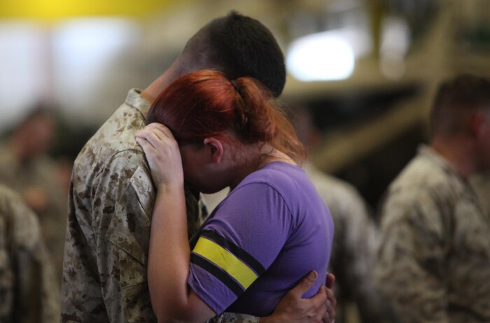 A Marine with Retrograde and Redeployment in support of Reset and Reconstitution Operations Group, 2nd Marine Logistics Group hugs his wife before deploying aboard Camp Lejeune, N.C., May 16, 2013. Service members with the unit left for Afghanistan on a seven-month deployment, where they are scheduled to organize equipment for relocation within the Marine Corps. 