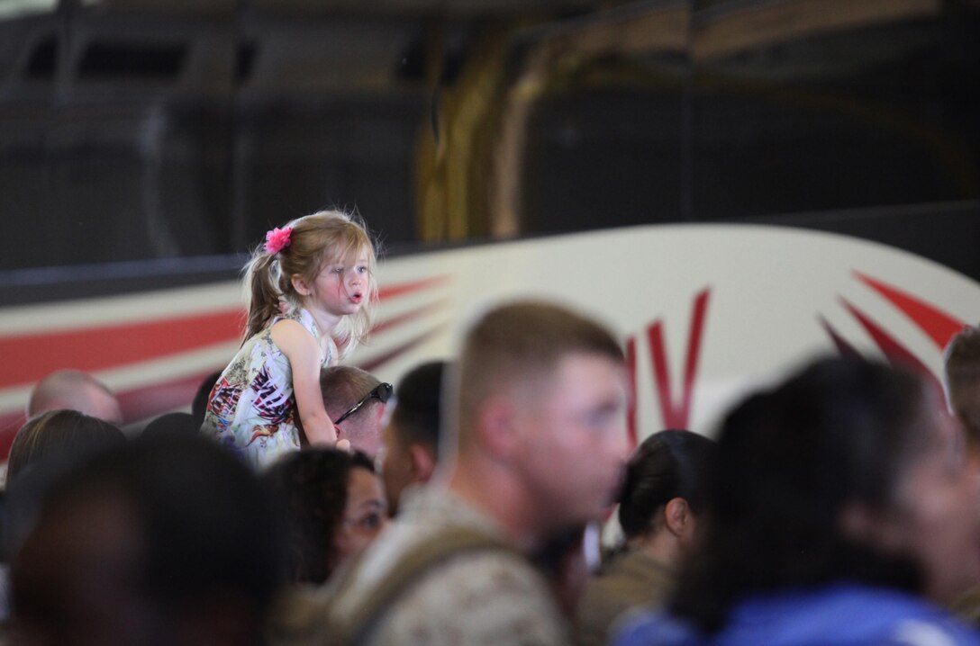 A young girl searches for a family member with Retrograde and Redeployment in support of Reset and Reconstitution Operations Group, or R4OG, 2nd Marine Logistics Group before the unit deploys to Afghanistan aboard Camp Lejeune, N.C., May 16, 2013. The Marines and sailors with R4OG trained for several months in preparation for the deployment to prepare and ship Marine Corps equipment back to the United States.