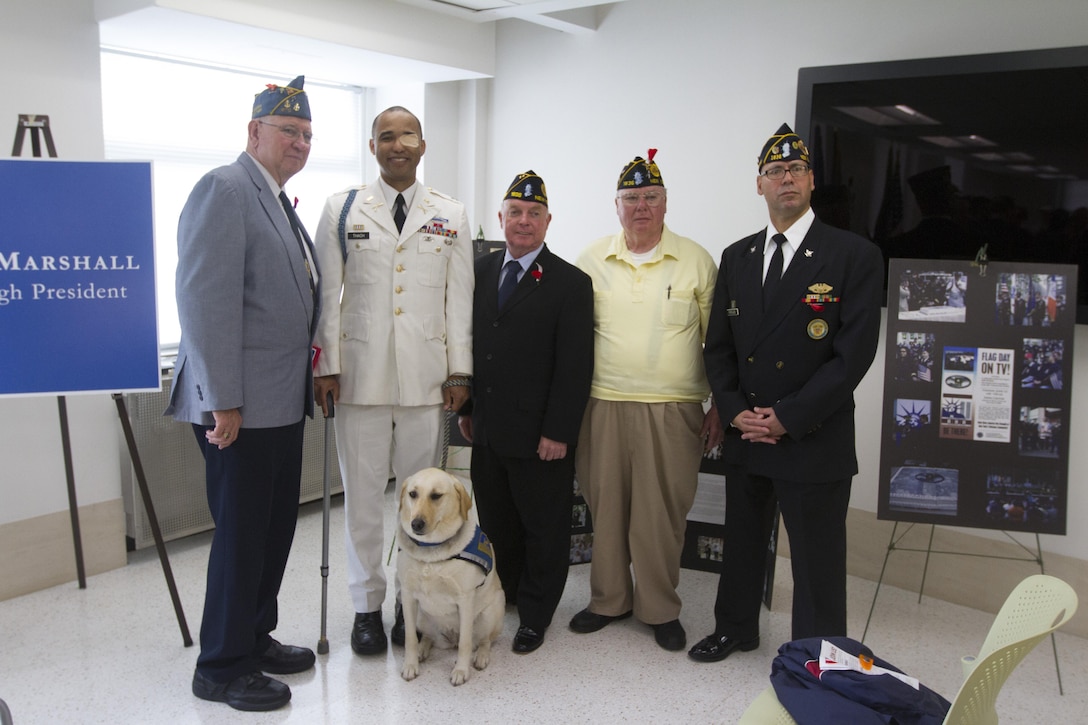 QUEENS, N.Y. -- Retired Army Capt. Janes Van Thach, a wounded veteran, poses with fellow veterans at the Queens Borough Memorial Day ceremony May 22, at the Queens Borough Hall.  Thach continues to support veterans across the nation whenever the he has the opportunity.  (U.S. Marine Corps photo by Lance Cpl. Daniel E. Valle).
