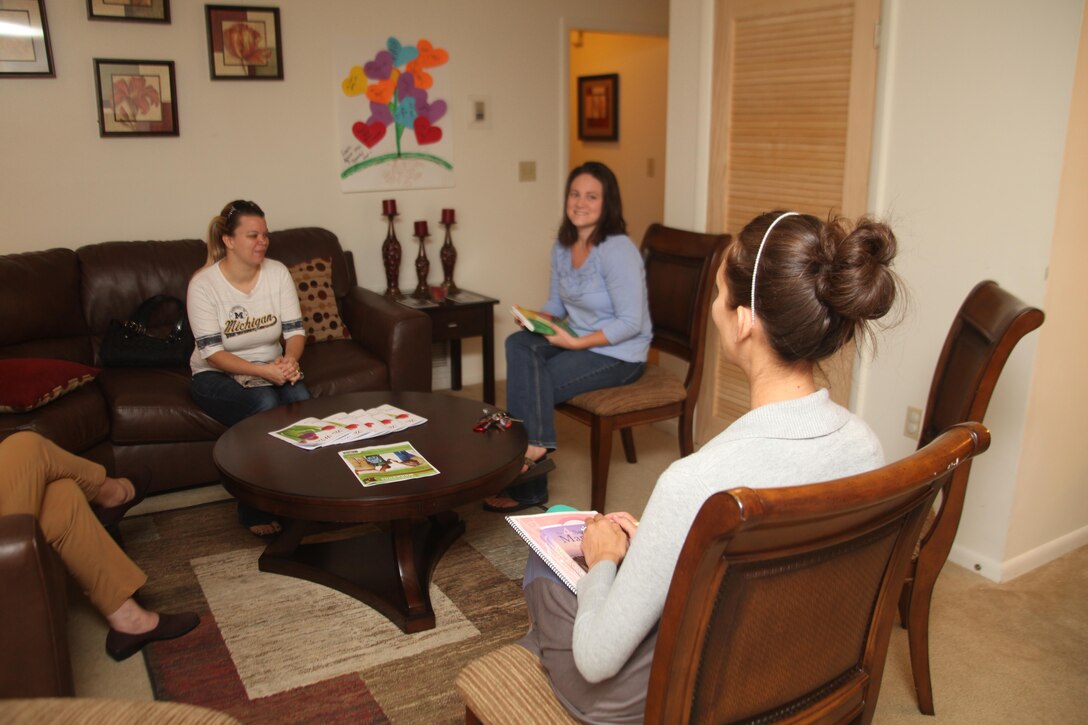 Teresa Neuer and Allison Scott, whose spouses are stationed at the Air Station meet at the Marine Corps Family Team Building House with Nicole Shea, the readiness and support program trainer for MCFTB, aboard Laurel Bay for the Read Your way Through Deployment class, May 16. In this class spouses gather bi-weekly to discuss books that are chosen to help them with the stresses of deployment.