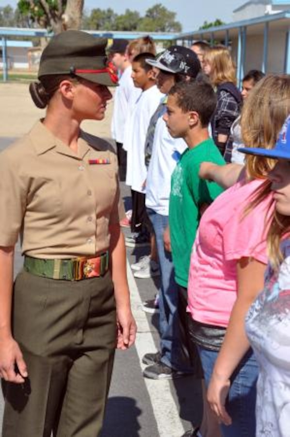 Corporal Bryanna Kessler, a stableman with the Marine Corps Mounted Color Guard on Marine Corps Logistics Base Barstow, Calif., inspects students of Yermo Elementary School, May 16. As part of a social studies class on the Civil War, Marines with MCLB Barstow volunteered to show the students different aspects of military life.


