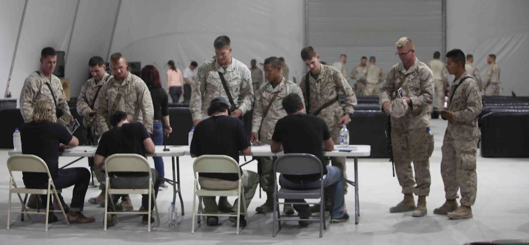 Members of the country music band The Frontmen sign autographs for Marines with 2nd Battalion, 8th Marine Regiment, Regimental Combat Team 7, and other units at the Morale, Welfare and Recreation center here, May 23, 2013. "It's about providing that intimate setting where we talk to the crowd-- hang out with the crowd," said Tim Rushlow. "When we get the opportunity to come play for the troops, it's a major no-brainer and natural fit for us as major patriots that we'd come out and do it because we support all military that give us our freedom." (U.S. Marine Corps photo by Lance Cpl. Mel Johnson)